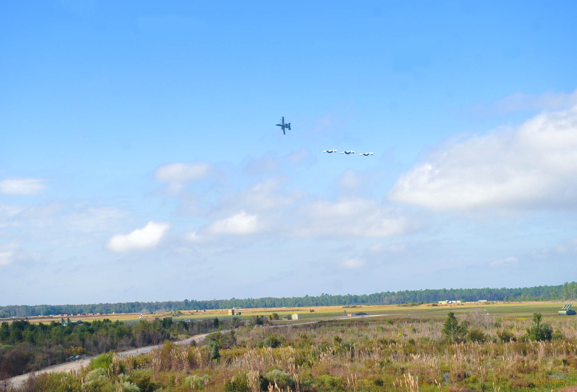 A formation of A-10C Thunderbolt II’s fly over Grand Bay Bombing and Gunnery Range during a training demonstration for the guests of the 2012 Flying Tigers Reunion at Moody Air Force Base, Ga., Oct. 25, 2012. The reunion included an A-10 training demonstration, a tour of the base and a reunion dinner. (U.S. Air Force photo by Airman 1st Class Olivia Bumpers/Released) 