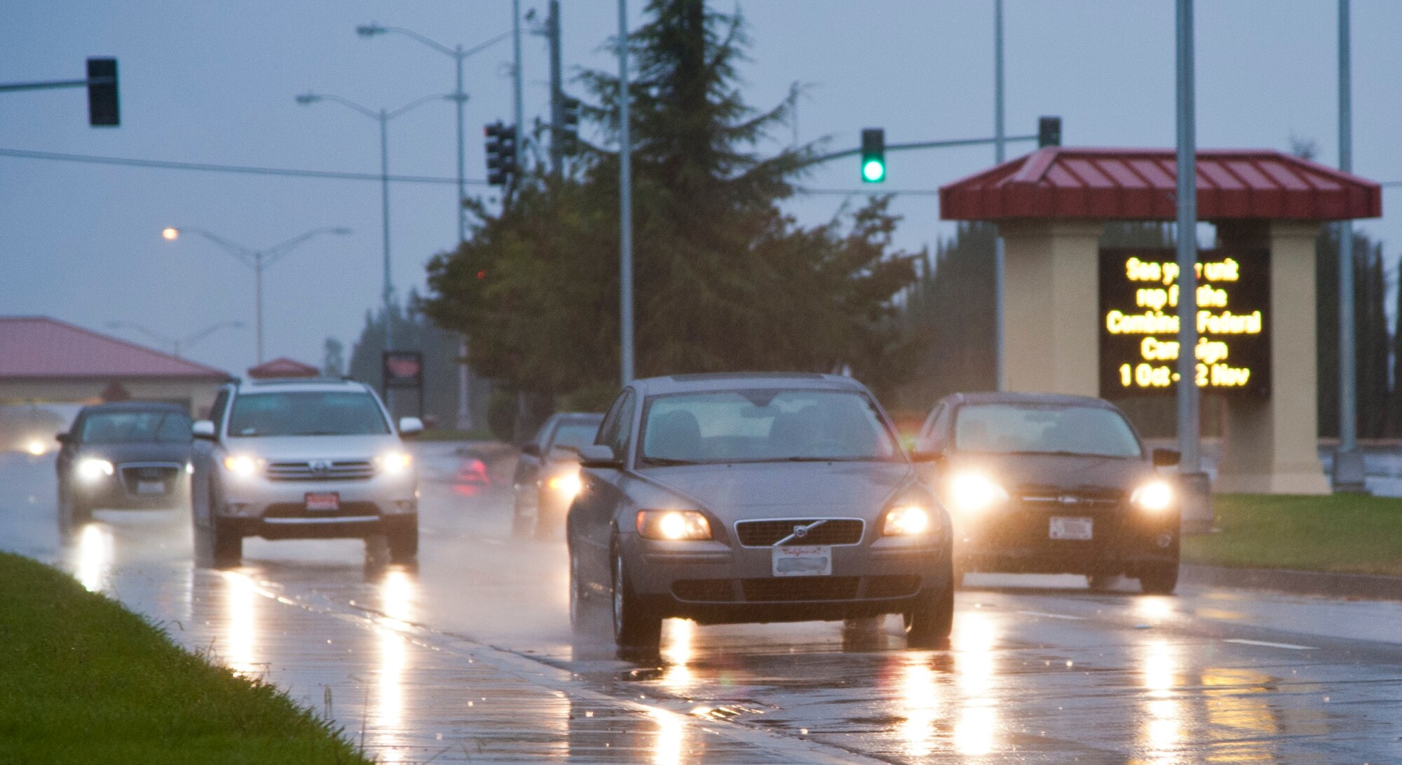 Travis drivers use caution while driving on base during the first major rain fall Oct. 22. Drivers are reminded to slow down since roads can become slick from oil build-up. (U.S. Air Force photo/Airman 1st Class Nicole Leidholm) (Photo diigitally altered. License plates blurred out to protect personal privacy)