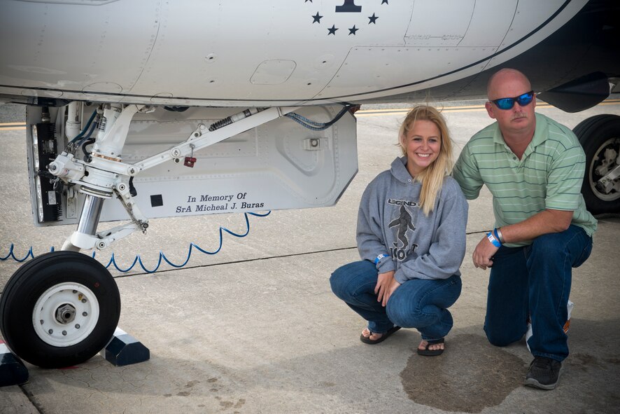 Family members of fallen warrior U.S. Air Force Senior Airman Michael J. Buras, pose next to an F-16 Thunderbird Fighting Falcon during the Moody Air Force Base, Ga., Legacy of Liberty Open House air show Oct. 27, 2012. Thunderbird No. 1 was flown in memory of Buras who died in Kandahar, Afghanistan, Sept. 21, 2010. (U.S. Air Force photo by Senior Airman Douglas Ellis/Released) 
