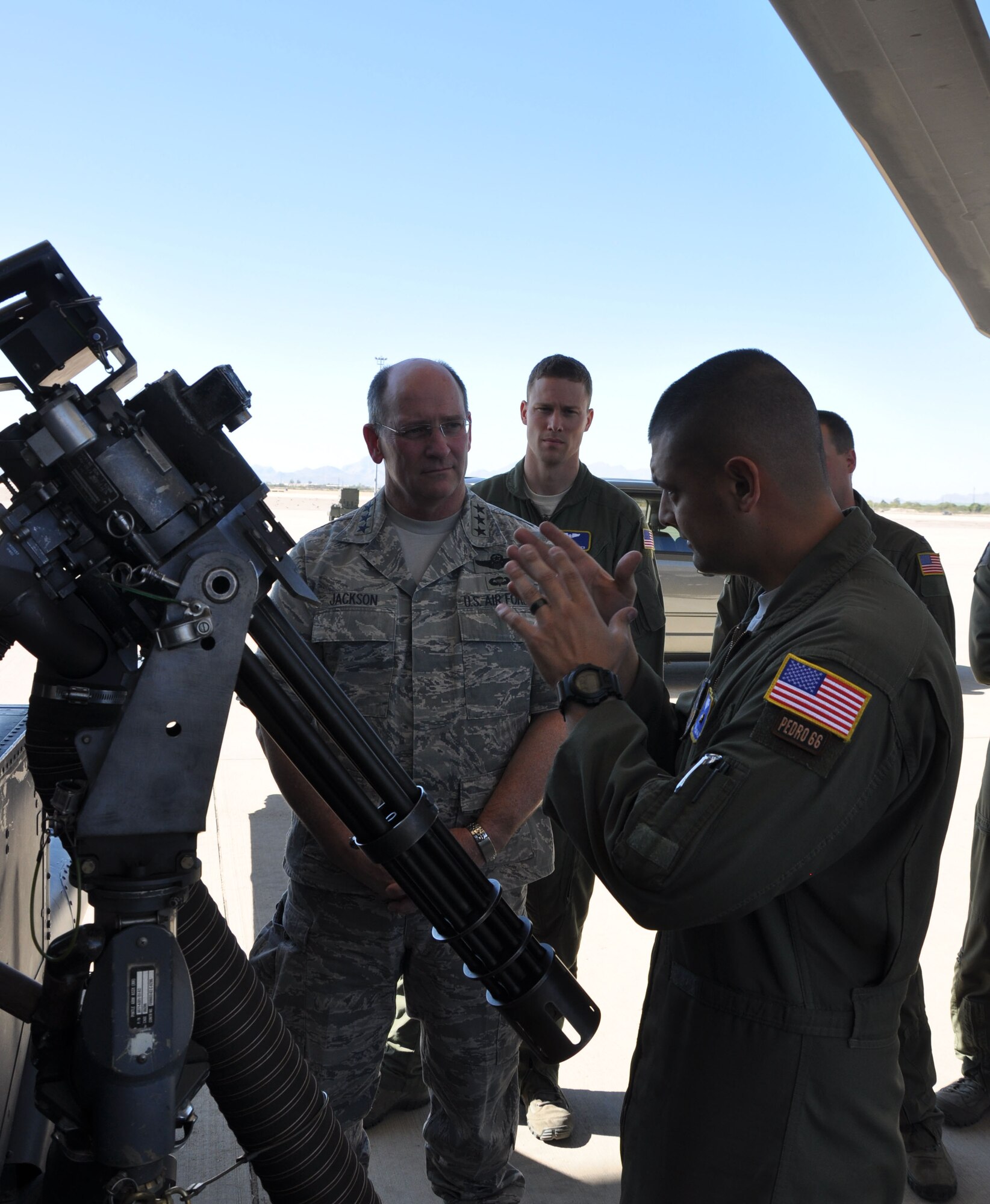 Tech. Sgt. Antonio Jimenez, aerial gunner with the 305th Rescue Squadron, explains the capabilities of the M134 mini gun on the HH-60 Pave Hawk helicopter to Lt. Gen. James F. Jackson, Air Force Reserve Commander during his first ever visit as AFRC commander to the 943rd Rescue Group.  The general witnessed firsthand the rescue capabilities of 943rd RQG and interacted with Reserve Airmen stationed at Davis-Monthan Air Force Base, Ariz.  (U.S. Air Force photo/ Master Sgt. Luke Johnson)