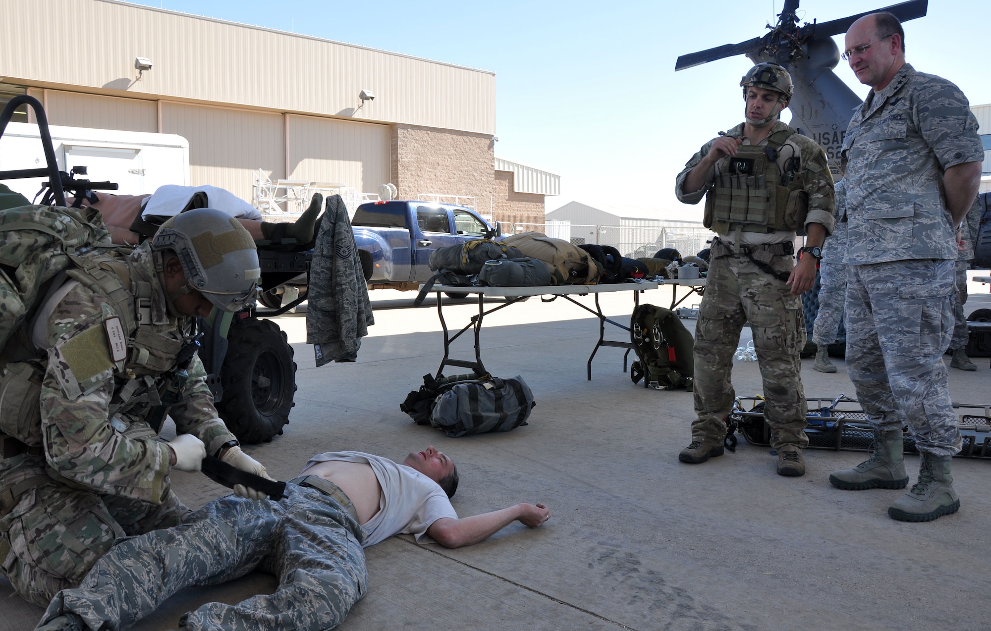 Lt. Gen. James F. Jackson, Air Force Reserve commander, observes a pararescue (PJ) medical demonstration during his visit to the 943rd Rescue Group, October 26, 2012.  Staff Sgt. Alan Brumfield, a PJ with the 306th Rescue Squadron, explains to General Jackson how PJ’s treat battlefield wounded and injured as Staff Sgt. Richard Dunn prepares a tourniquet. During his visit to the group, the general got witness firsthand the capabilities of 943rd RQG and meet with Reserve Airmen stationed at Davis Monthan Air Force Base, Ariz. (U.S. Air Force photo/ Master Sgt. Luke Johnson) 