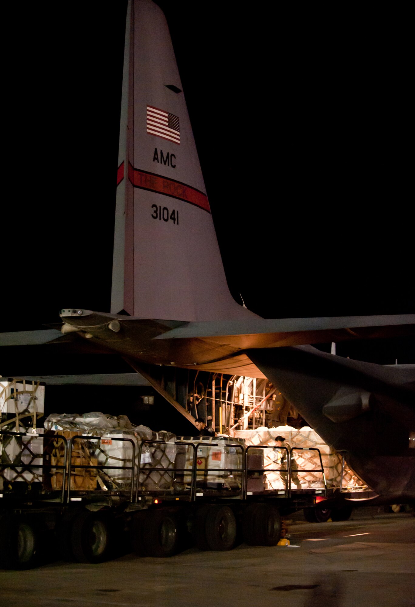 Airmen offload cargo pallets from a 60K loader onto a C-130H Hercules prior to a night mission at Bagram Airfield, Afghanistan, Oct. 25, 2012. The C-130H is a tactical airlift workhorse for American and coalition forces in Afghanistan. (U.S. Air Force Photo/Staff Sgt. Jeff Nevison)