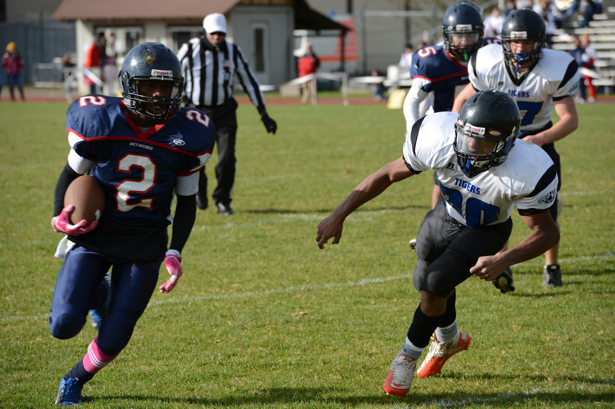BITBURG ANNEX, Germany -- Corey Evans, Bitburg Barons running back from Tampa, Fla., runs past Hohenfels Tigers defenders during the Barons’ final home game Oct. 27, 2012, at Rik Carr Field. Evans is also a defensive back for the Barons and will play at the Division-II championship game against Naples in Baumholder 2: 30 p.m., Nov. 3, 2012. (U.S. Air Force photo by Senior Airman Natasha Stannard/Released)
