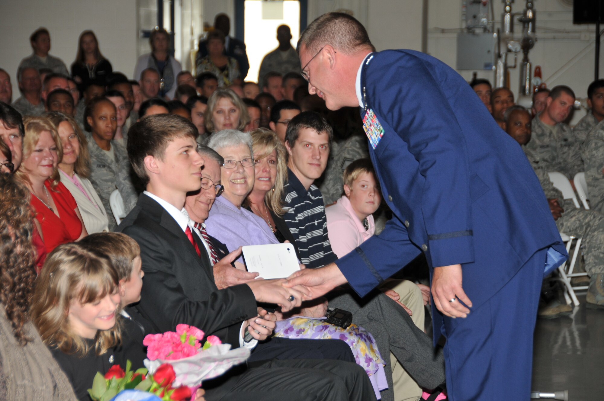 After accepting command for the 145th Airlift Wing during an Assumption of Command ceremony, Col. Roger E. Williams, Jr., thanks his wife Jena Williams for her continuous support, along with their daughter Danielle and sons Dane and Ryan, Col Williams’ father, Roger E. Williams, Sr., his mother Lizzie and his sisters Ann and Peggy along with Peggy’s husband Eddie and their sons Blayne and Hunter.  (National Guard photo by Tech. Sgt. Rich Kerner, 145th Public Affairs)