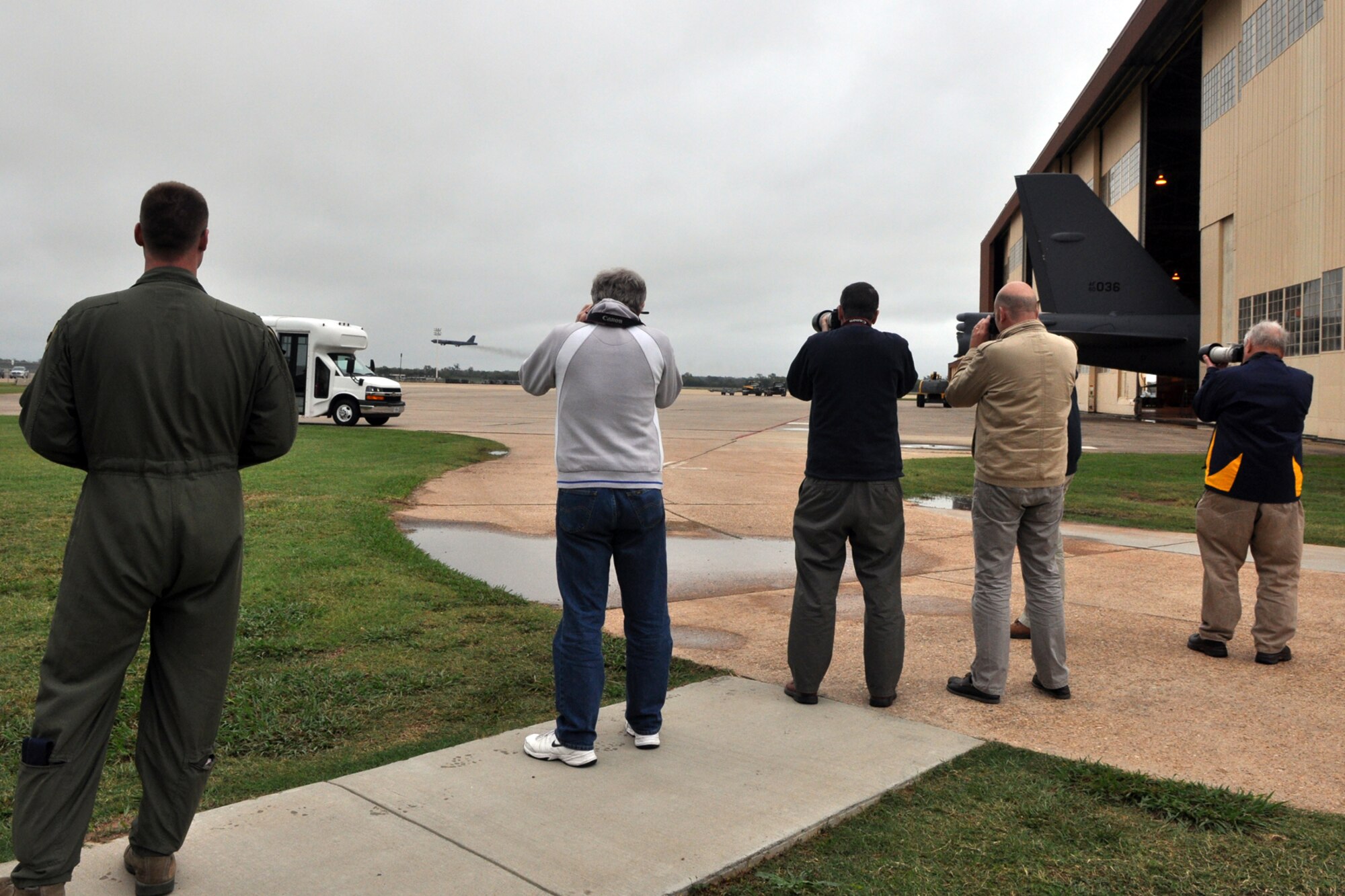 A group of aviation enthusiasts from England photograph a B-52 Stratofortess as it takes off from the runway at Barksdale Air Force Base, La., Oct. 26, 2012. The British visitors are members of the RAF Fairford Aviation Society in England. They will also attend the “Wings Over Houston Air Show” at the Ellington Airport during their visit to the United States. (U.S. Air Force photo by Master Sgt. Jeff Walston)   