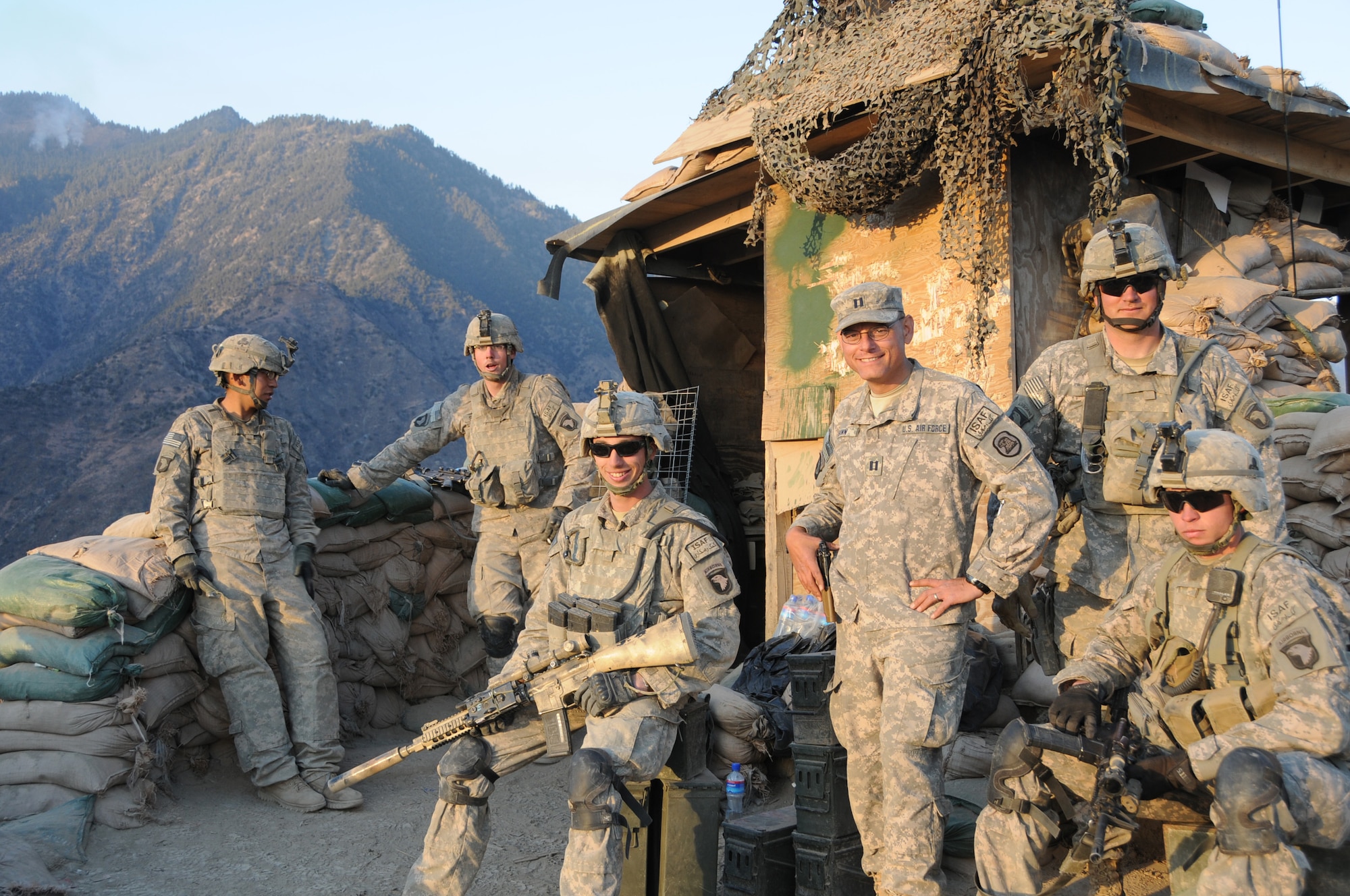 Captain Peter Shinn, an Officer Training School instructor, with Soldiers at Outpost Mace in Kunar Province, Afghanistan, Dec. 20, 2010. Shinn won an Emmy? for videography in Afghanistan. He was part of a team that put together Iowa Soldiers Remember Afghanistan, which aired on Iowa Public Television on Veterans Day in 2011. The program won the 2012 Emmy? for best Military Program in the Upper Midwest Region. (U.S. Army photo.)