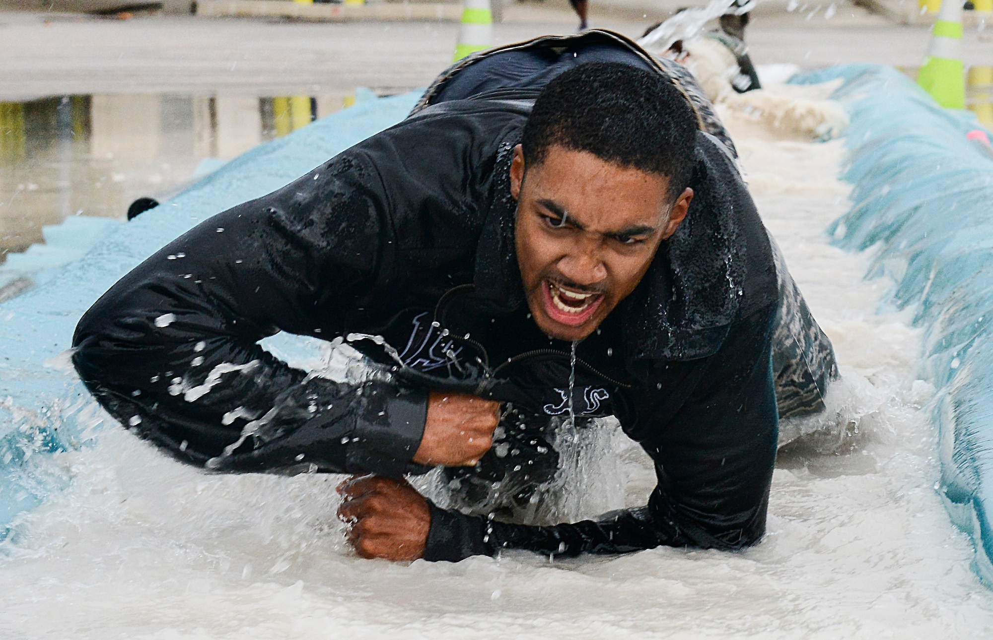 Staff Sgt. Frederick Hines, 31st Fighter Wing, low crawls through water during the 2nd Annual Tech. Sgt. Israel Del Toro Combat Run held Oct. 26 at Aviano Air Base, Italy. The run was held in honor of Del Toro, a former 8th Air Support Operations Squadron member severely injured in Afghanistan in 2005. (U.S. Air Force photo by Senior Airman Katherine Tereyama)
