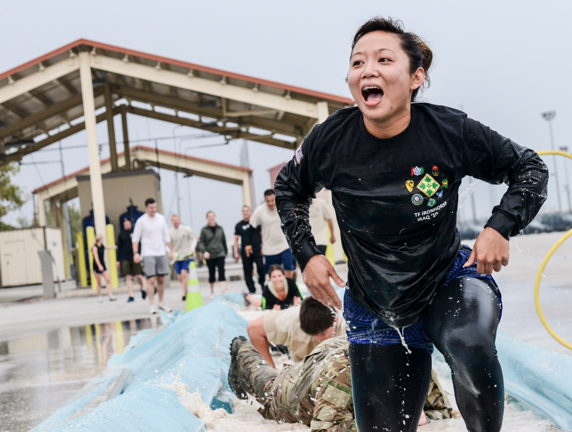 An Aviano Airman emerges from a pool of water during the 2nd Annual Tech. Sgt. Israel Del Toro Combat Run held Oct 26 at Aviano Air Base, Italy. More than 200 people participated in the race, which included a wall jump, balance beam, low crawl course, sandbag carry and several other obstacles on the 5-kilometer course. (U.S. Air Force photo by Senior Airman Katherine Tereyama) 