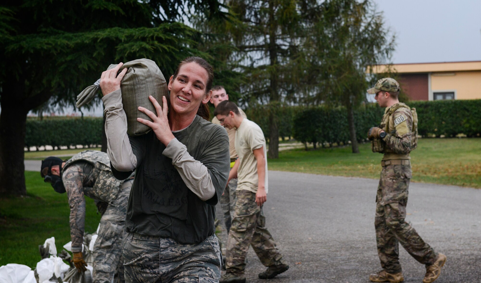 An Aviano Airman carries a sandbag during the 2nd Annual Tech. Sgt. Israel Del Toro Combat Run held Oct 26 at Aviano Air Base, Italy. More than 200 people participated in the race, which included a wall jump, balance beam, low crawl course, sandbag carry and several other obstacles on the 5-kilometer course. (U.S. Air Force photo by Senior Airman Katherine Tereyama) 
