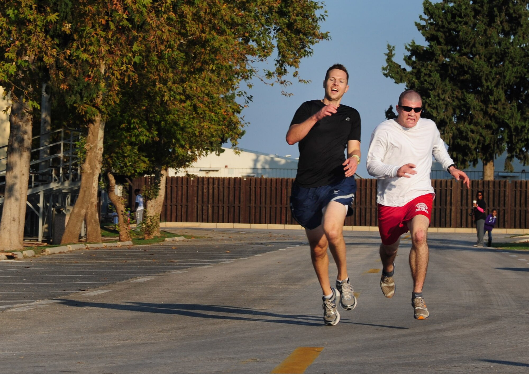Chad Gregory, 39th Security Forces Squadron, right, and Jason Clute, 39th Force Support Squadron, race to the finish line during the Triple Ribbon 5k run Oct. 27, 2012, at Incirlik Air Base, Turkey. Gregory and Clute tied for first place with a final run time of 18 minutes, 34 seconds. (U.S. Air Force photo by Senior Airman Anthony Sanchelli/Released)
