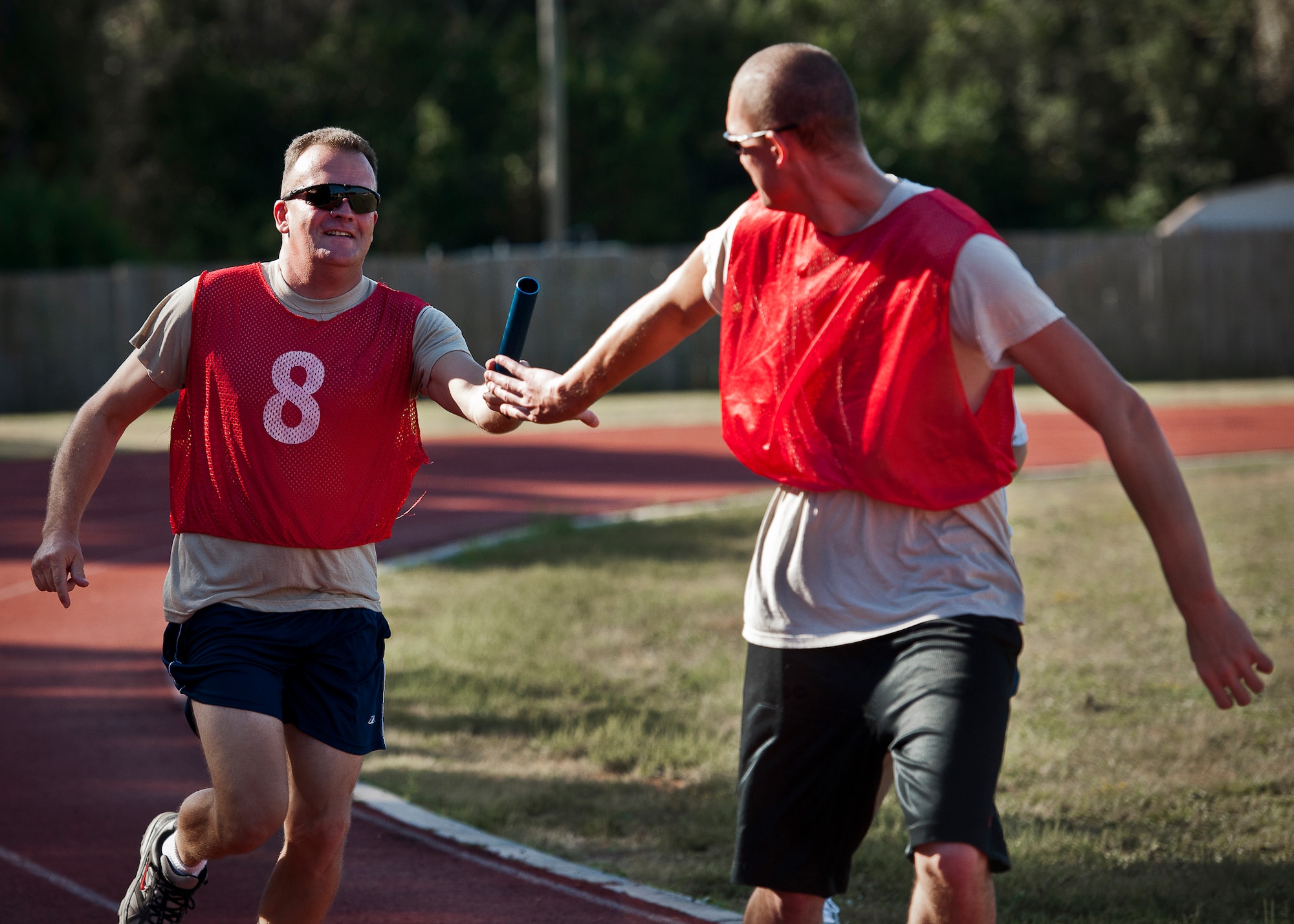 The baton is successfully passed during the 400-meter relay at a 96th Mission Support Group sports day Oct. 26 at Eglin Air Force Base, Fla.  Eglin Airmen participated in ultimate football, track and field events, softball and golf.  The event helped raise money for the Combined Federal Campaign.  (U.S. Air Force photo/Samuel King Jr.)