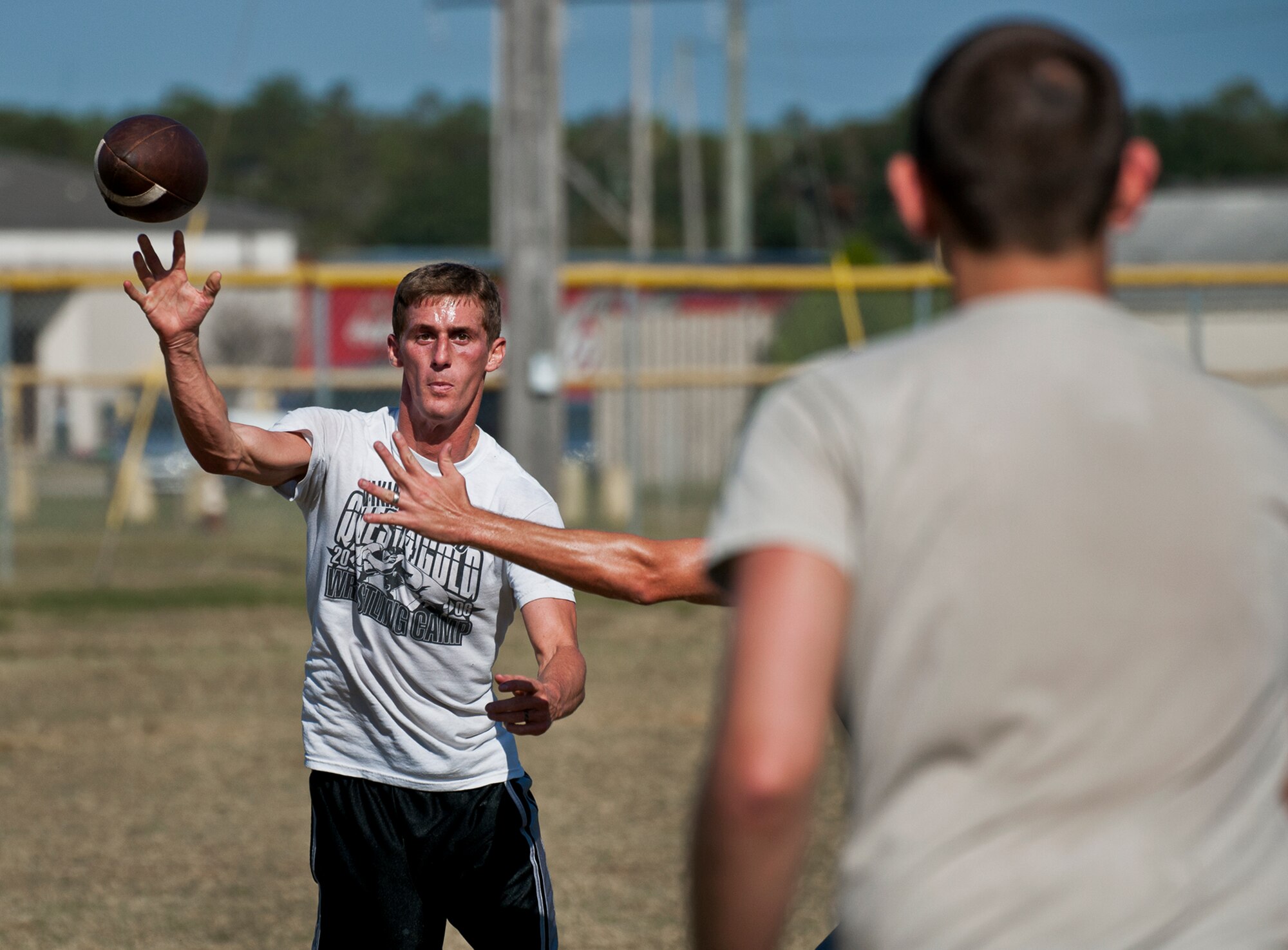 A 96th Logistics Readiness Squadron Airman passes to his teammate during a game of ultimate football at a 96th Mission Support Group sports day Oct. 26 at Eglin Air Force Base, Fla.  Eglin Airmen participated in ultimate football, track and field events, softball and golf.  The event helped raise money for the Combined Federal Campaign.  (U.S. Air Force photo/Samuel King Jr.)