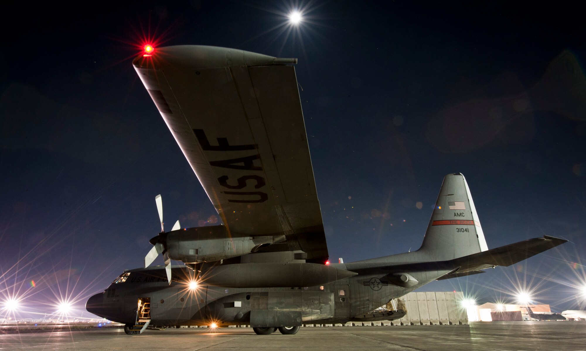 A C-130H Hercules sits ready to conduct a night mission at Bagram Airfield, Afghanistan, Oct. 25, 2012. The “Herc” provides daily tactical airlift support to combat forces in Afghanistan. (U.S. Air Force photo/Capt. Raymond Geoffroy)