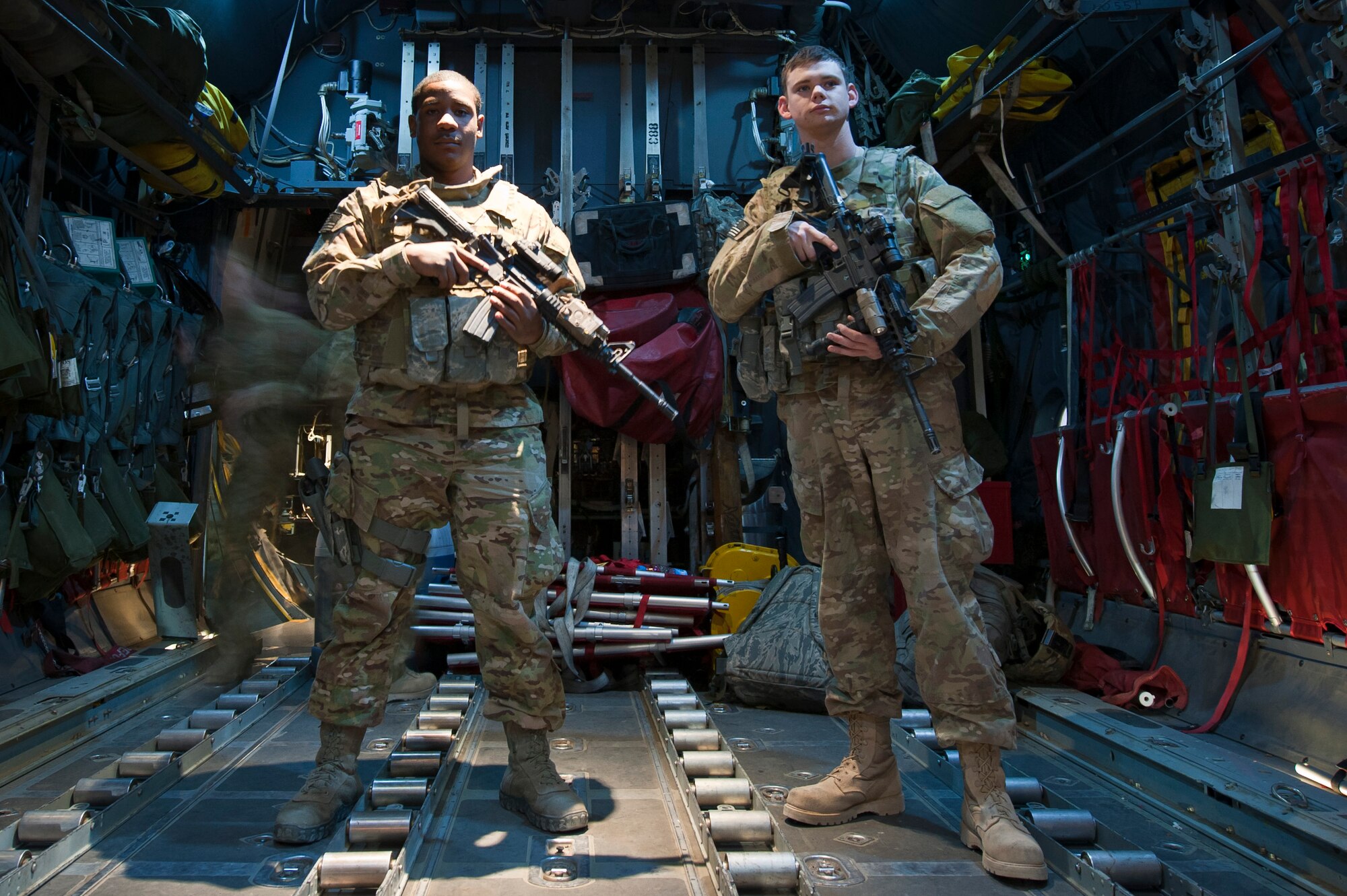 455th Expeditionary Security Forces Squadron Fly-Away Security Team members Senior Airman Jonathan Harris (left) and Airman 1st Class Ryan Albritton stand in the cargo bay of a C-130H Hercules prior to a night mission at Bagram Airfield, Afghanistan, Oct. 25, 2012. FAST Airmen provide force protection to aircrews performing day and night tactical airlift operations. (U.S. Air Force photo/Capt. Raymond Geoffroy)