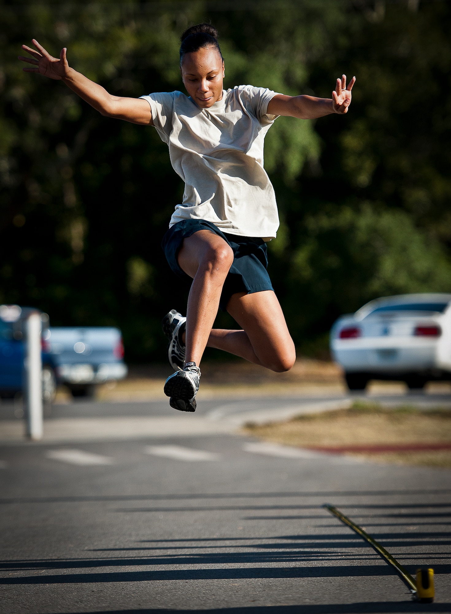 Senior Airman Whitney Rountree, of the 96th Aerospace Medicine Squadron, performs a triple-jump at a 96th Mission Support Group sports day Oct. 26 at Eglin Air Force Base, Fla.  Eglin Airmen participated in ultimate football, track and field events, softball and golf.  The event helped raise money for the Combined Federal Campaign.  (U.S. Air Force photo/Samuel King Jr.)
