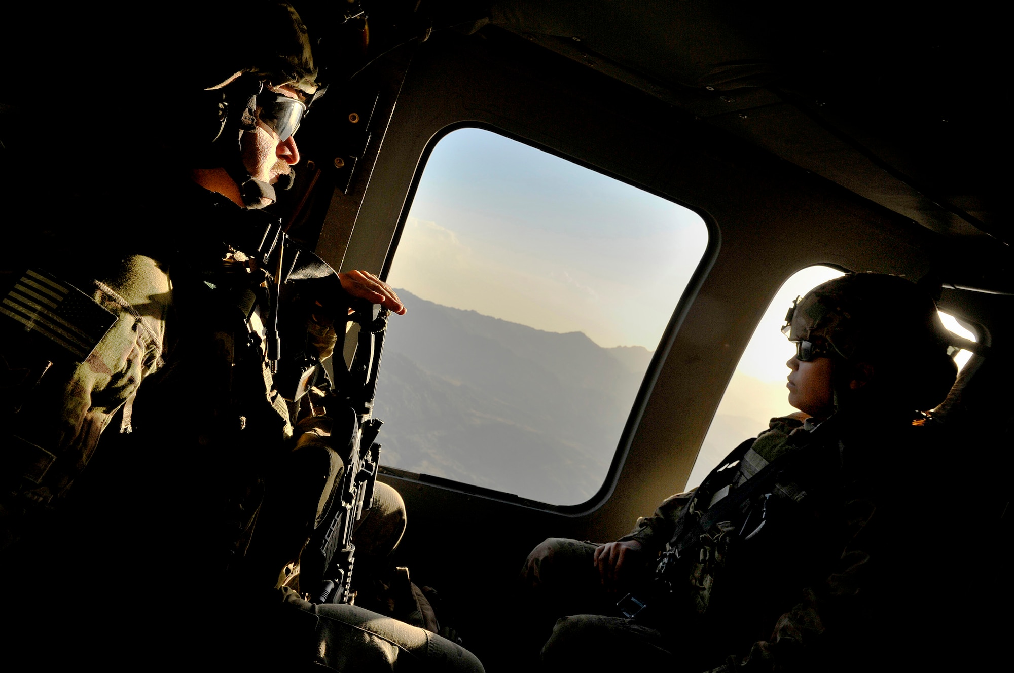 U.S. Air Force Staff Sgt. Richard DeBolt, Joint Terminal Attack Controller, 817th Expeditionary Air Support Operations Squadron,  scans the below terrain during a short helicopter flight to a forward operating base in the Kunar Province of Afghanistan, Oct. 4, 2012. DeBolt is deployed from Ft. Carson, CO., and is tasked to support ground operations in Regional Command-East, near the Pakistan border. DeBolt and fellow JTAC members provide ground forces with air superiority by controlling overhead aircraft that are able to deliver multiple weapons systems, as well as intelligence, surveillance, and reconnaissance capabilities. JTACs and Radio Operators, Maintainers, and Drivers train and operate alongside their Army counterparts in order to prepare them for kinetic situations while outside the wire. (U.S. Air Force photo/Staff Sgt. Clay Lancaster)