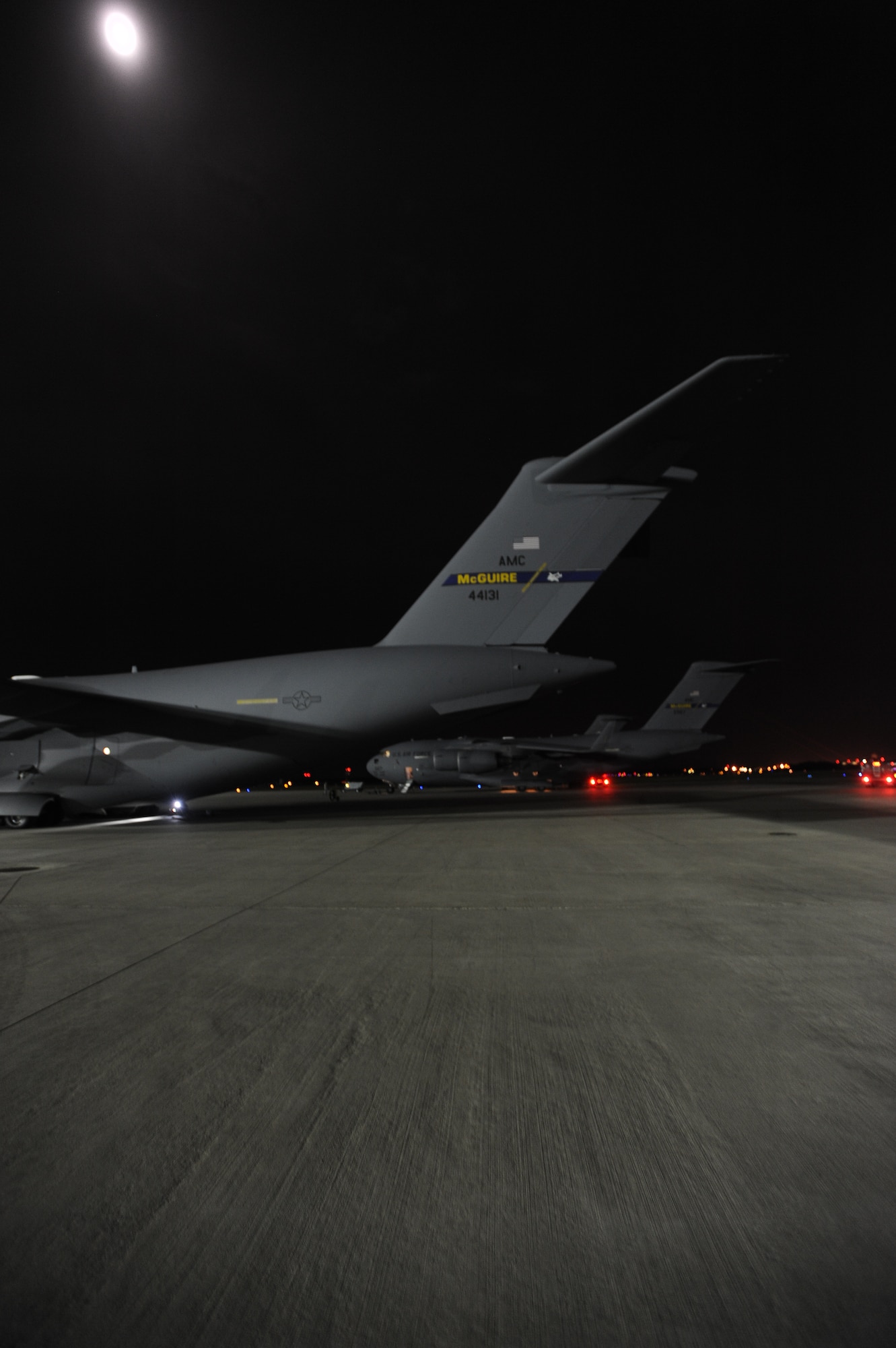 JOINT BASE MCGUIRE-DIX-LAKEHURST, N.J.--Two C-17 Globemaster IIIs stand ready for cargo on McGuire Field here Oct. 27, 2012, as 621st Contigency Response Wing members prepare to evacuate equipment prior to Hurricane Sandy's arrival. (U.S. Air Force photo by Airman Sean Crowe/ Released)