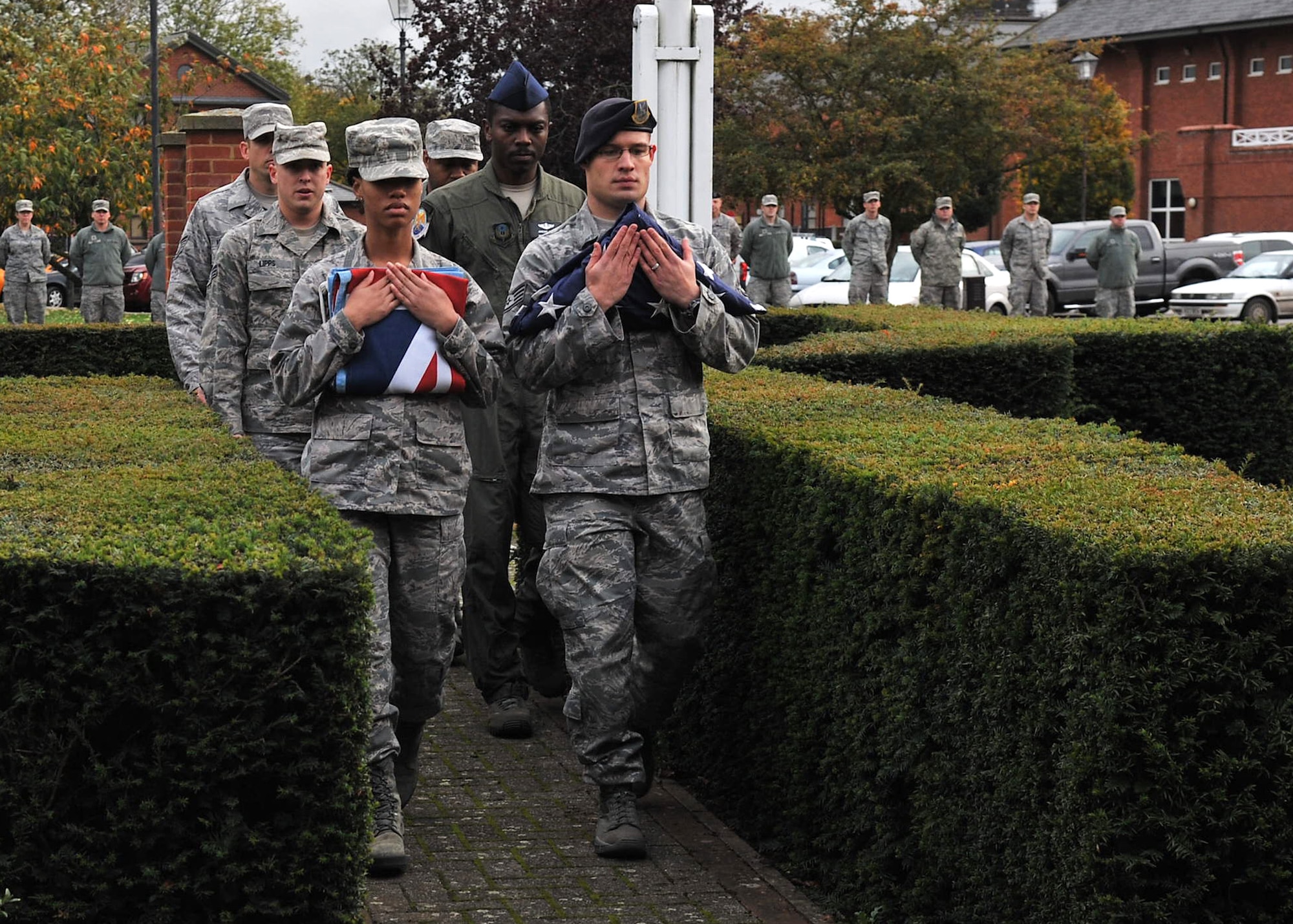Airmen from the 352nd Special Operations Group perform a flag folding detail during a retreat ceremony Oct. 26, 2012, on RAF Mildenhall. Retreat signifies the end of the duty day whilst paying respect to the American and British flags. (U.S. Air Force photo by Senior Airman Jerilyn Quintanilla/Released)