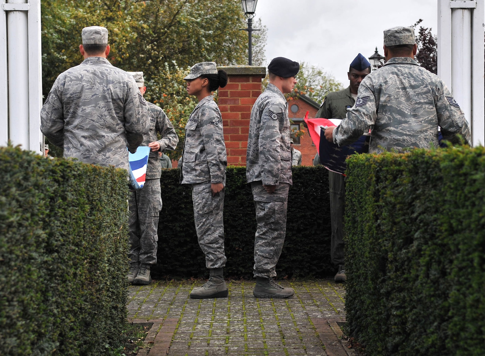 Airmen from the 352nd Special Operations Group fold the American and British flags during a retreat ceremony Oct. 26, 2012, on RAF Mildenhall, England. Retreat pays respect to the American and British flags as well as signifies the end of the duty day. (U.S. Air Force photo by Senior Airman Jerilyn Quintanilla/Released)