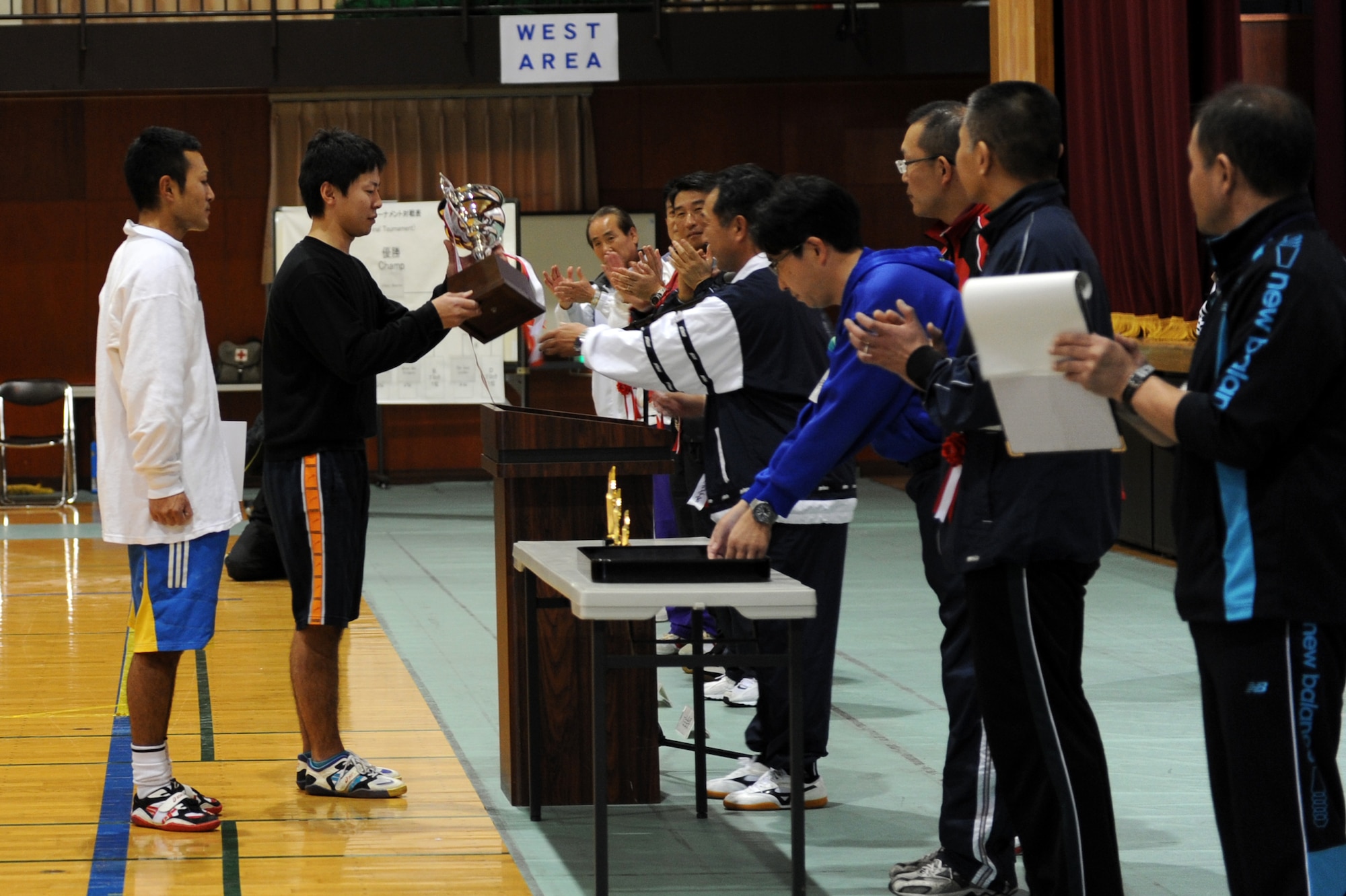 Representatives from the Northern Aircraft Control and Warning Wing’s team Crazy Horse accept the first place trophy during the 11th Annual Northern Air Defense Force Commander’s Cup tug-of-war event at Misawa Air Base, Japan, Oct. 27, 2012. Nineteen teams competed, but team Crazy Horse stood above the rest and received the first place prize, the commander’s cup. (U.S. Air Force photo by Airman 1st Class Kia Atkins)