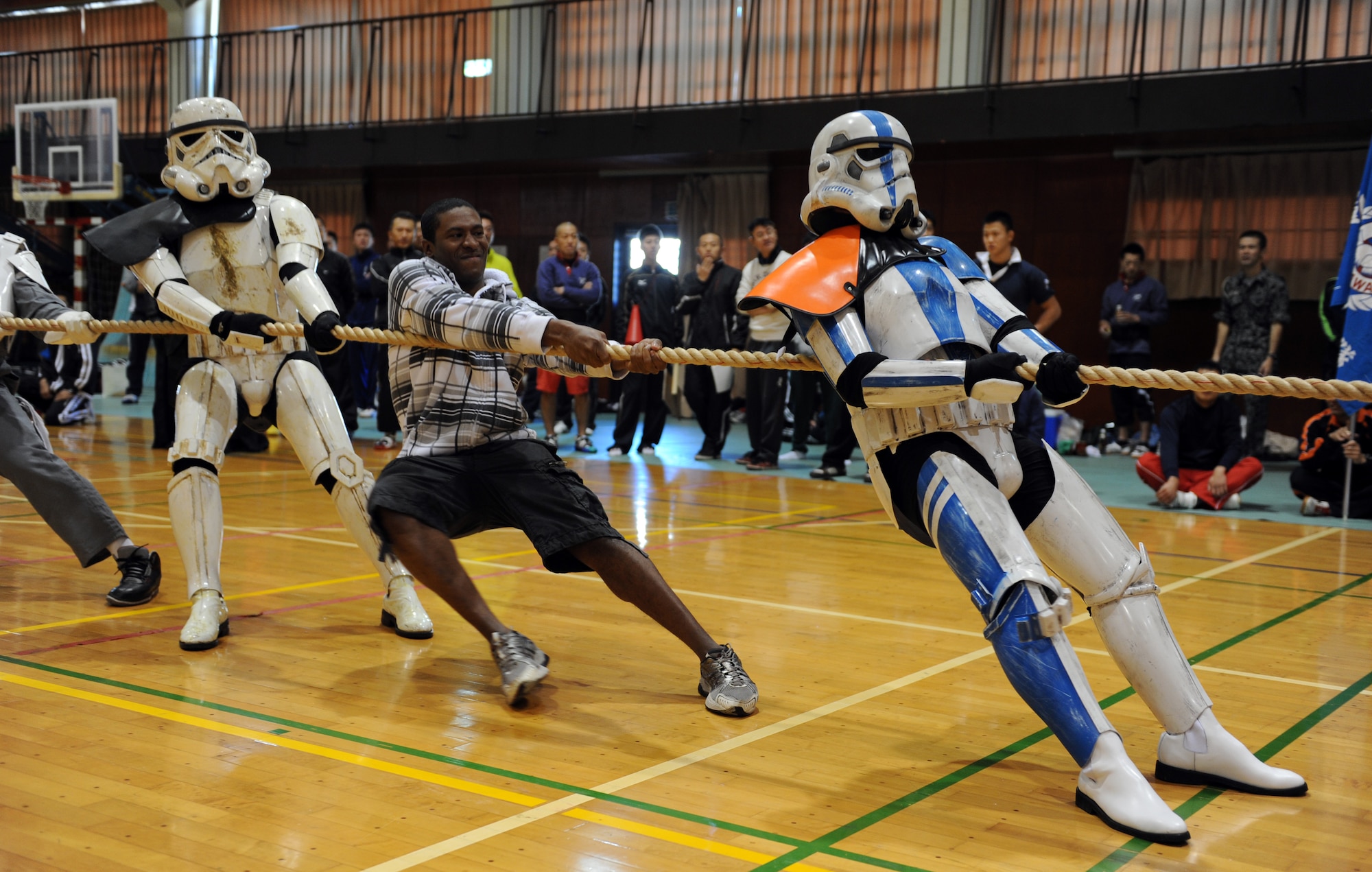 35th Maintenance Squadron Avionics Pointy Heads team members compete in tug-of-war at Misawa Air Base, Japan, Oct. 27, 2012. The Avionics Pointy Heads along with 18 other teams competed for the Commander’s Cup during the 11th Annual Northern Air Defense Force Commander’s Cup tug-of-war event. By promoting teamwork, the competition helped strengthen bonds and improve bilateral relations between U.S. and Japanese Forces. (U.S. Air Force photo by Airman 1st Class Kia Atkins)