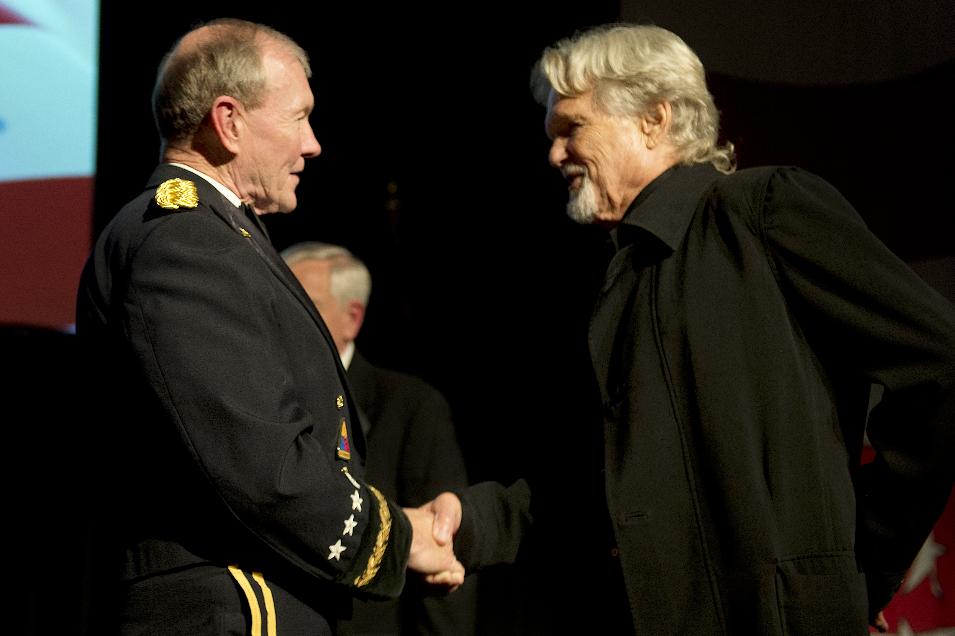 Kris Kristofferson, actor and songwriter, right, shakes hands with Army  Gen. Martin E. Dempsey, chairman of