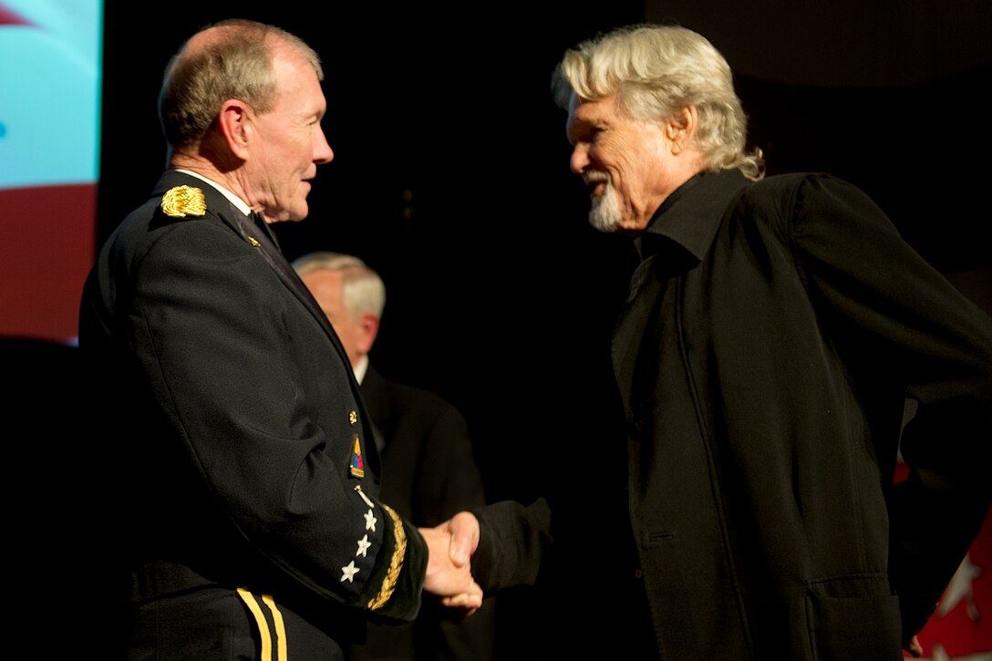 Kris Kristofferson, actor and songwriter, right, shakes hands with Army Gen. Martin E. Dempsey, chairman of the Joint Chiefs of Staff, at the conclusion of the USO of North Carolina’s 8th annual Salute to Freedom Gala in Raleigh, N.C., Oct. 27, 2012. 