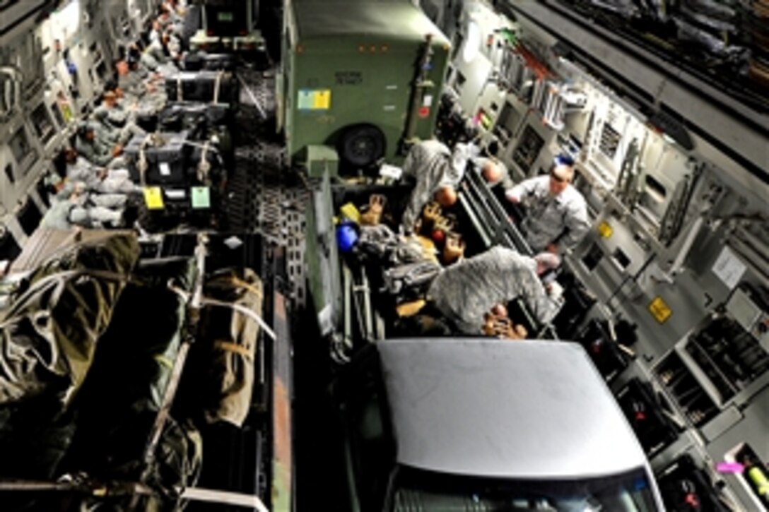 About 65 airmen fly aboard a C-17 Globemaster III  from Joint Base McGuire-Dix-Lakehurst, N.J., Oct. 28, 2012, to MacDill Air Force Base, Fla., to stay out of the path of Hurricane Sandy. This movement ensures Air Mobility Command maintains the capability to respond to natural disasters or worldwide contingencies. The airmen are assigned to the 621st Contingency Response Wing on the New Jersey base.