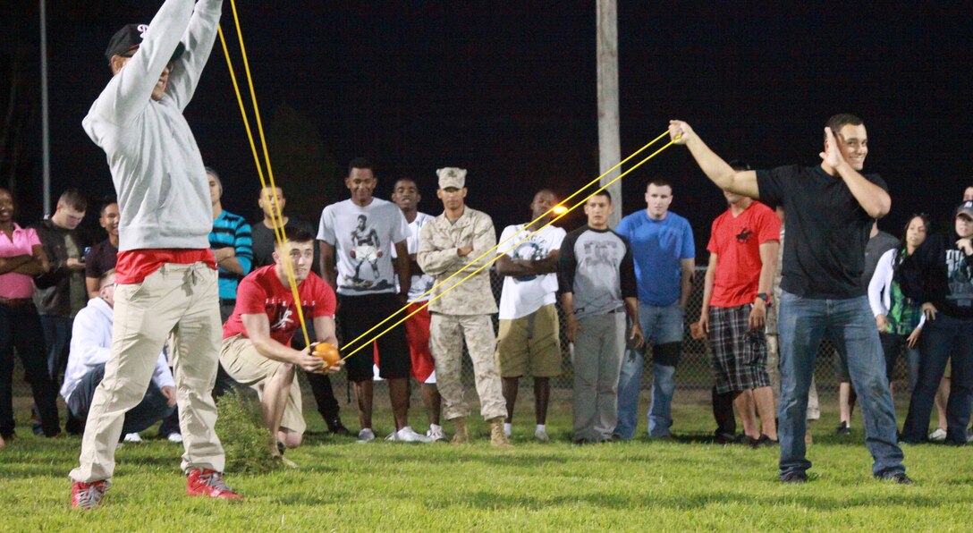 Marines with 1st Supply Battalion, Combat Logistics Regiment 15, 1st Marine Logistics Group, launch a small pumpkin during the 1st Supply Bn. Barracks Bash at Camp Pendleton, Calif., Oct. 25. The celebration included a pie-eating contest, pumpkin carving, and a pork shoulder cooking contest.