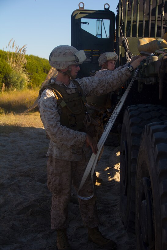 Marines of Combat Logistics Battalion (CLB) 26 secure empty water bladders to the bed of a 7-ton truck at the beach operations center at Onslow Beach, N.C., 23 Oct., 2012. CLB-26 is one of the three reinforcements of 26th MEU, which is slated to deploy in 2013.