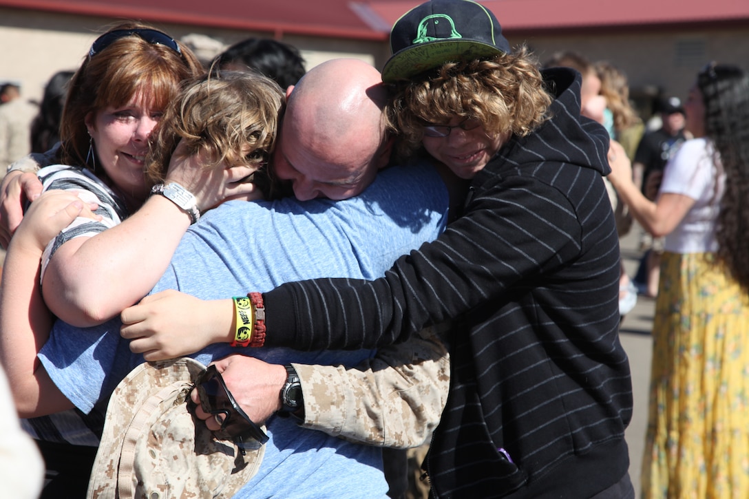 Master Sgt. Jackie Canaday, explosive ordnance disposal chief, 1st Explosive Ordnance Disposal Company, 7th Engineer Support Battalion, 1st Marine Logistics Group, greets his family after a deployment to to Helmand province, Afghanistan, Oct. 26. Families and friends waited patiently at Camp Pendleton, Calif., for their loved ones following a seven month tour in support of Operation Enduring Freedom.