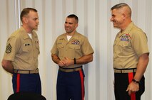 Major General Joseph L. Osterman awards a coin to SSgt. Joshua Benne for his outstanding work as the staff non-commisioned officer in-charge of Recruiting Sub-Station Dubuque, Iowa. Osterman is the Commanding General for Marine Corps Recruiting Command.