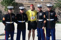 Sergeant John Trickler stands for a photo with the Marines of Engineer Support Maintenance Company, 4th Marine Logistics Group after completing the Omaha Marathon. Sgt. Trickler is a canvassing recruiter with Recruiting Sub-Station Ames, Iowa. 