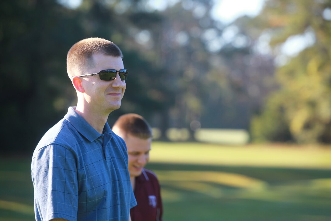 1st Lt. Timothy A. Burnam (foreground) and Capt. John E. Conrad Jr., communications officers with Combat Logistics Regiment 27, 2nd Marine Logistics Group, share a laugh after a teammate misses the hole during a golf-tournament fundraiser at the Paradise Point golf course aboard Camp Lejeune, N.C., Oct. 24, 2012. CLR-27 organized the event to support its Marine Corps Birthday Ball. 
