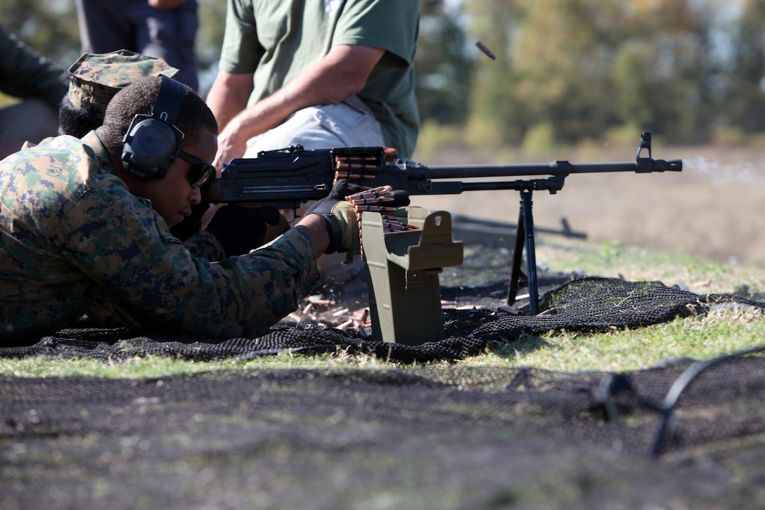 121023-M-WB921-270 Crawfordsville, Ark. -- Sgt. Geoffrey Andrade, feeds rounds into a foreign machine gun for Sgt. Brain Oldaker during a foreign weapons training session at the Tier 1 Group Training Facility in Crawfordsville, Ark., Oct. 23, 2012. The Marines and Sailors of Special-Purpose MAGTF Africa learned ho to operate and maintain various foreign weapons in preparation for their upcoming deployment. (Official U.S. Marine Corps photo by Lance Cpl. Caleb McDonald/Released)