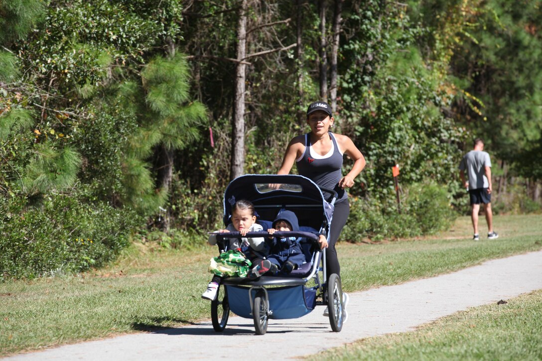 Participants race to the finish line during the Marine Corps Community Service Resilience Education’s Red Ribbon Week 5K Fun Run/Walk Oct. 22. Approximately 100 people ran and some wore red shirts to show their support. 