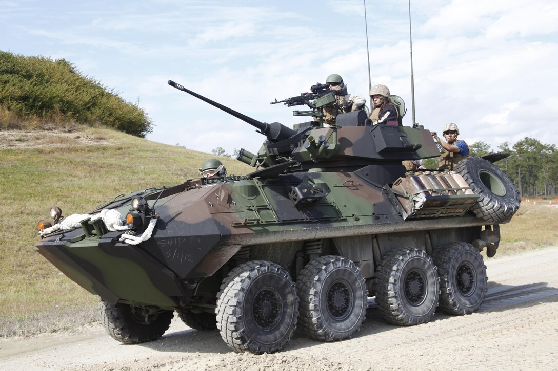 A light armored vehicle with 2nd Light Armored Reconnaissance Battalion gives a family a ride during Marine Light Attack Helicopter Squadron 467’s family day on Marine Corps Base Camp Lejeune, N.C., Oct. 19. Participants said the event helped the families understand why their Marines’ work is important.