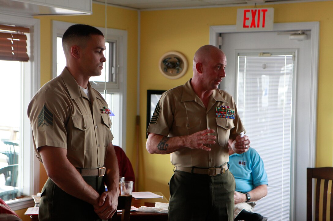 Sgt. Maj. Jeffrey V. Dagenhart, right, , speaks about Sgt. Michael Brawn , during a ceremony Friday in Atlantic Beach, N.C. Brawn received the Service Person of the Quarter Award from the Carteret County Chamber of Commerce Military Affairs Committee for volunteering more than 300 hours to the local community last year. Brawn is an ordnance instructor at the Center for Naval Aviation Technical Training; Dagenhart is the unit's sergeant major.