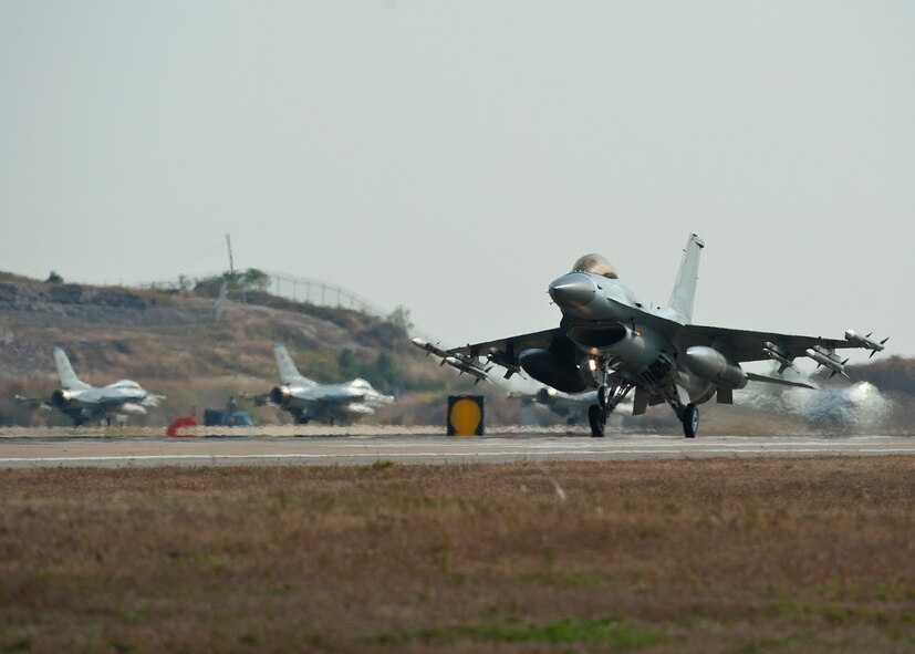 An F-16 Fighting Falcon with the 38th Fighter Group lands while other F-16s wait to takeoff during exercise Max Thunder 12-2 on Kunsan Air Base, Republic of Korea, Oct. 29, 2012. Max Thunder is a chance for U.S. and ROK ar forces to plan, execute and work side by side in various simulated scenarios and improves the capabilities and cohesion between the two. (U.S. Air Force photo/Staff Sgt. Jonathan Fowler)