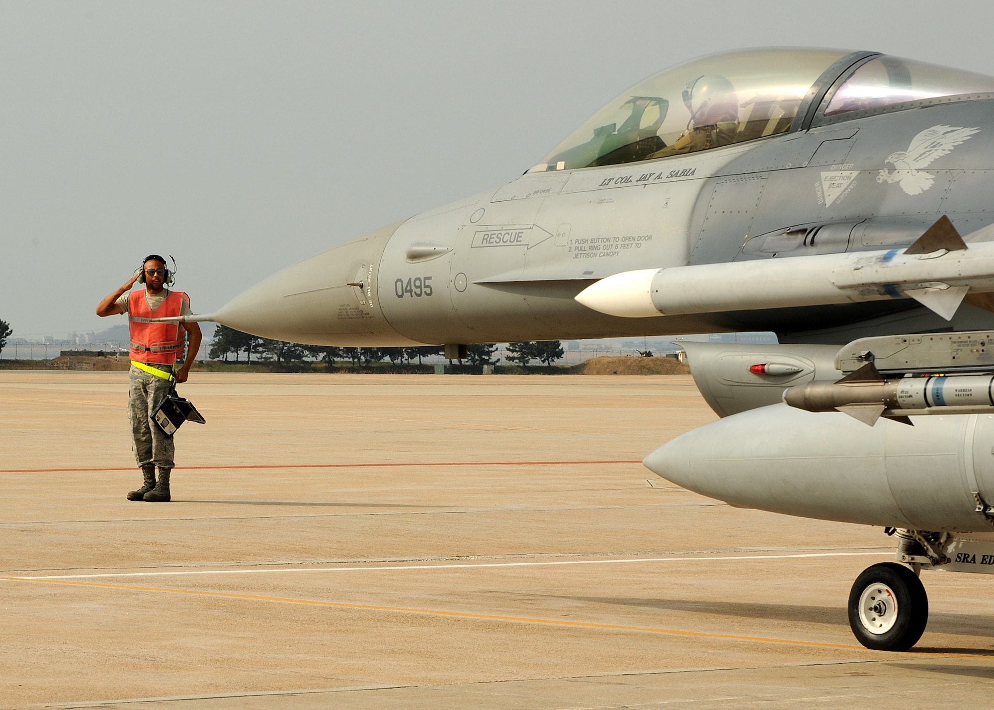 Senior Airman Antonio Williams, with the 4th Expeditionary Aircraft Maintenance Unit from Hill Air Force Base, Utah,  salutes as an F-16 Fighting Falcon prepares to taxi on Kunsan Air Base, Republic of Korea, Oct. 29, 2012. This is part of exercise Max Thunder 12-2, a combined exercise with ROK air force that features F-16s, F-15K Slam Eagles and numerous other aircraft. (U.S. Air Force photo/Staff Sgt. Jonathan Fowler)