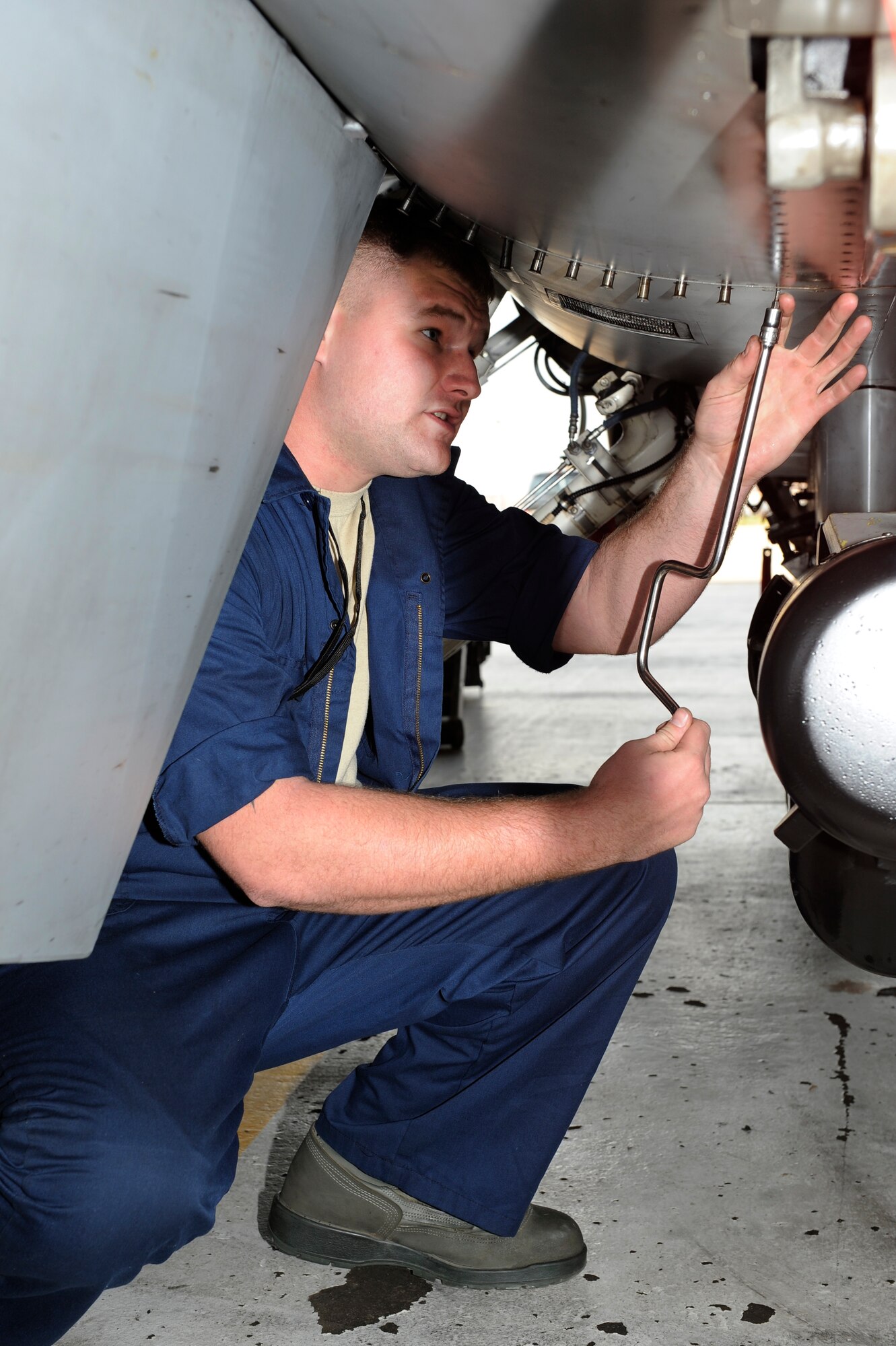 Senior Airman Samuel Strong, 8th Aircraft Maintenance Squadron, puts a panel back onto an F-16 Fighting Falcon during Max Thunder 12-2 at Kunsan Air Base, Republic of Korea, Oct. 30, 2012. To guarantee the pilot’s safety before takeoff, maintenance checks the aircraft for any problems. (U.S. Air Force photo/Senior Airman Marcus Morris)