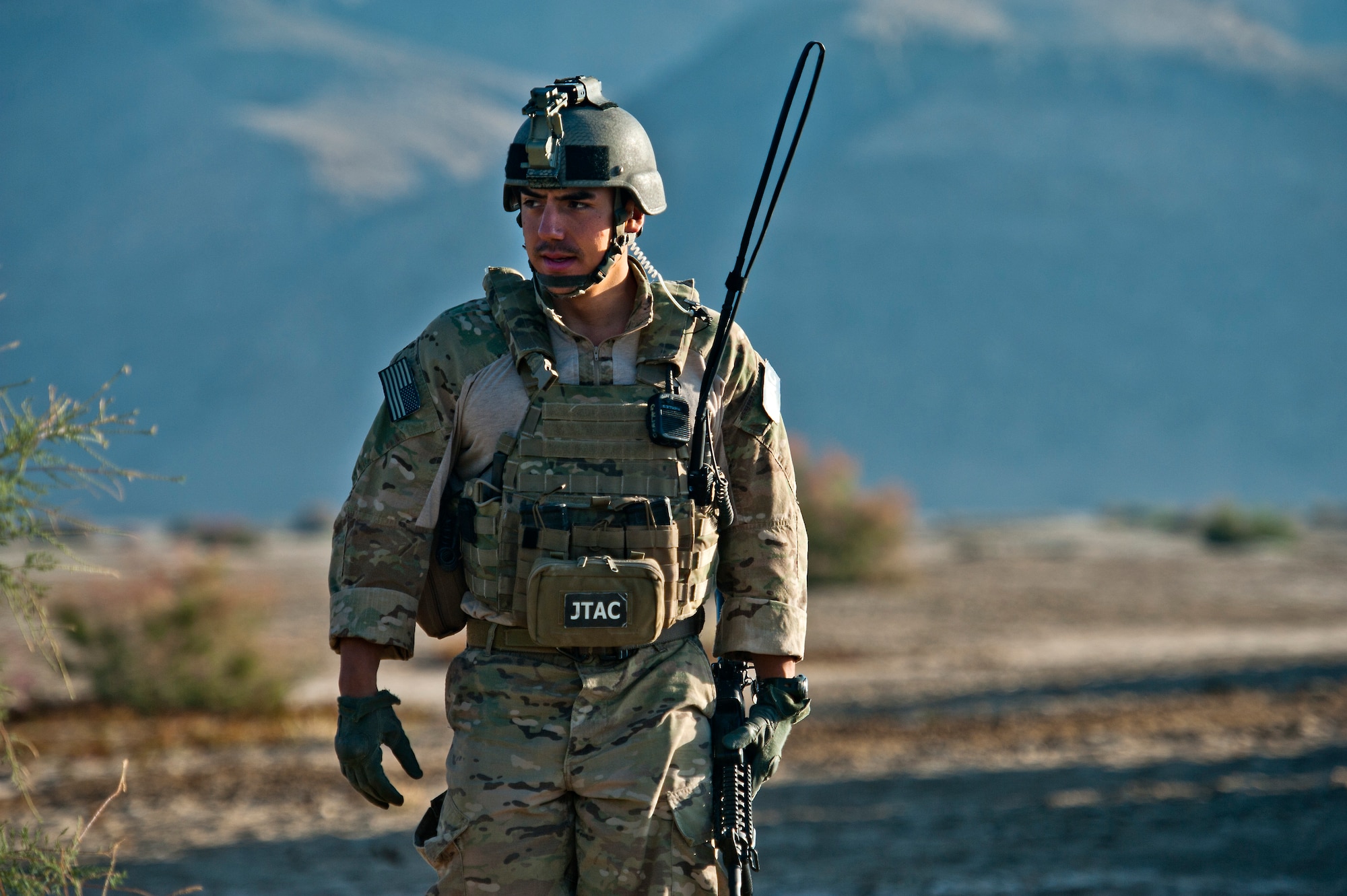 U.S. Air Force Joint Terminal Attack Controller, Senior Airman Cristobal Galindo, 807th Expeditionary Air Support Squadron, and native of San Bernardino, Calif., looks over the terrain on near Spin Boldak, Afghanistan, Oct. 13, 2011. Galindo is a about to go on a foot patrol with members of U.S. Army Alpha Troop, 2nd Squad, 38th Cavalry, Ft. Hood, Texas, to clear an area suspected to have insurgent activity and, if necessary, direct combat aircraft providing close air support. (U.S. Air Force photo/Master Sgt. Jeffrey Allen) 

