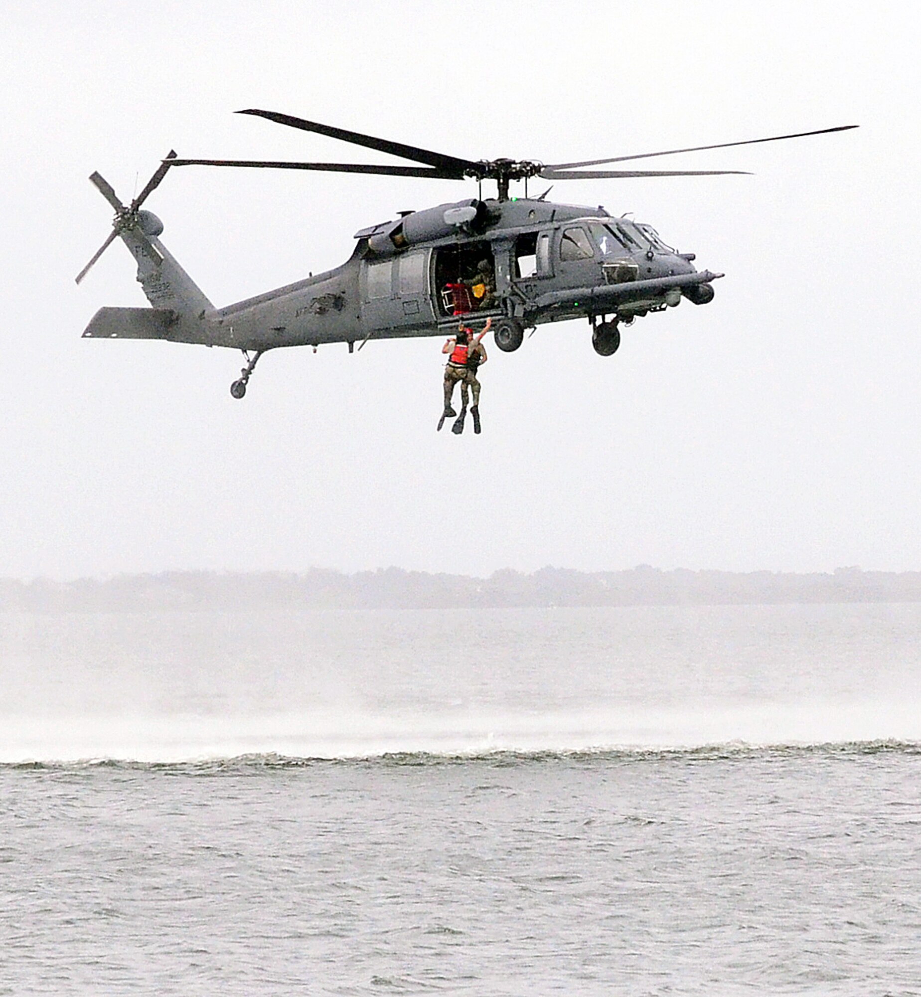 Paparescue jumpers are retrieved by an HH-60G Pave hawk during a training exercise over the Banana River near Patrick AFB, Fla. Oct. 25. Civic leaders from the greater Atlanta area were in attendance observing PJ activites. (U.S. Air Force photo/Senior Airman Elizabeth Van Patten)