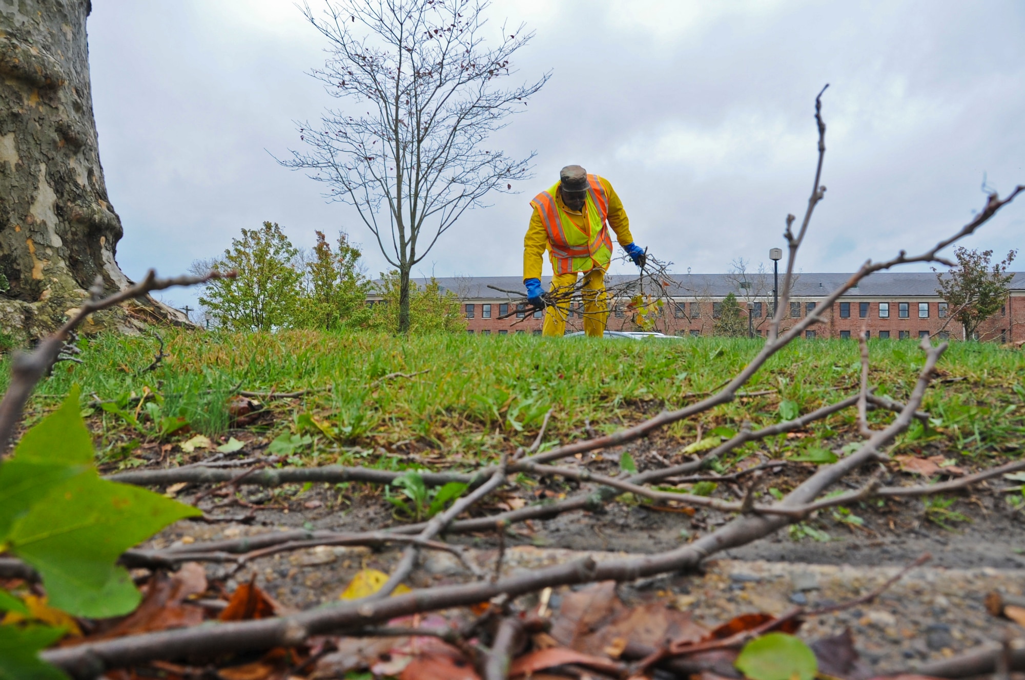JOINT BASE MCGUIRE-DIX-LAKEHURST, N.J. --  Robert Whitehead, a contractor with Pride Industries, picks up several Oct. 30, 2012. Several units from the joint base are responding to recover from the damage caused by Hurricane Sandy, which struck the base Oct. 29. Several inches of rain, combined with powerful winds, caused power outages in various base housing areas and unit facilities. (U.S. Air Force photo by Staff Sgt. David Carbajal/Released)