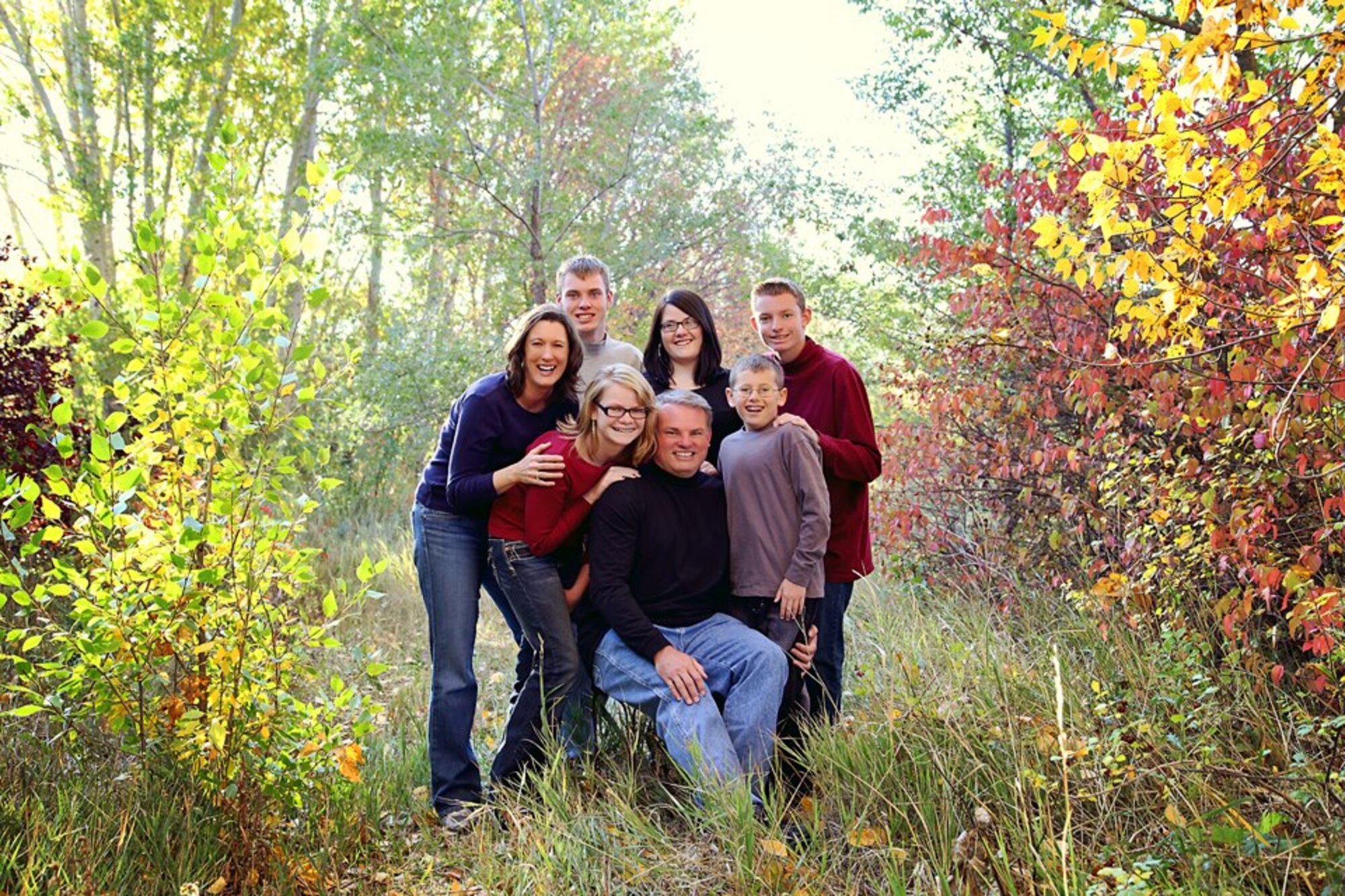 (From left to right) Col. Kay Barrish, Andy, DJ, Bob, Crystal, Adam, and Benjamin pose for family photos. Col Barrish and her husband, Bob, adopted two children and are in the process of adopting one more. (Photo by Amy Kachel) 
