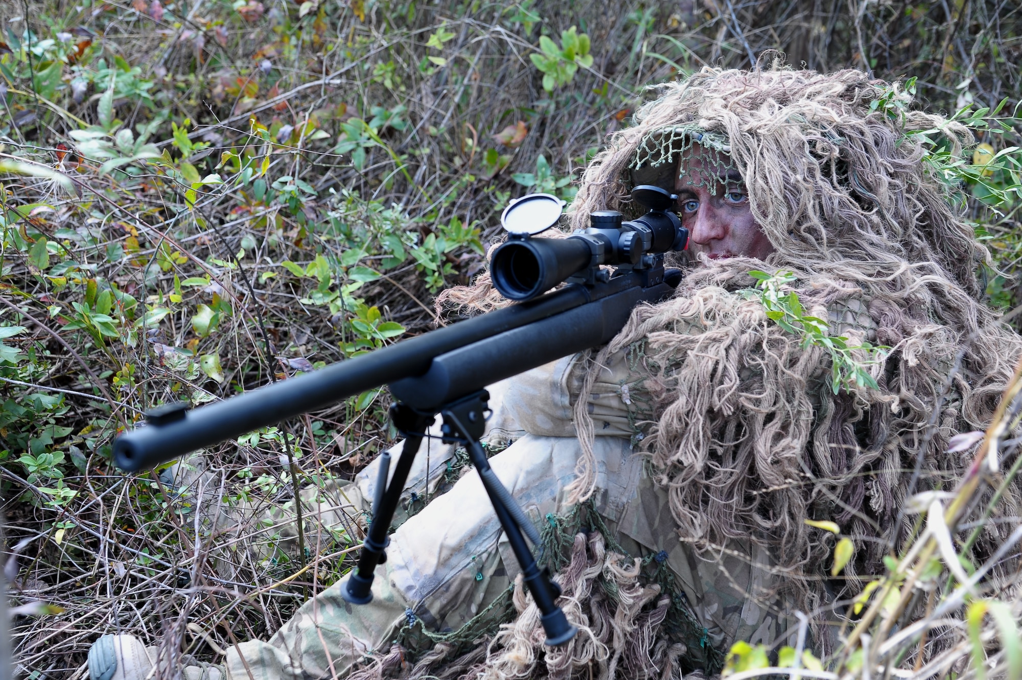 Airman 1st Class Tiffani Potter, 14th Security Forces Squadron demonstrates how to properly hold a sniper rifle while sitting and remain blended in to her surroundings Oct. 26 on Columbus Air Force Base. During the Close Precision Engagement Course students are taught how to maintain rifle control while allowing the least amount of visibility possible. (U.S. Air Force Photo/Airman 1st Class Charles Dickens