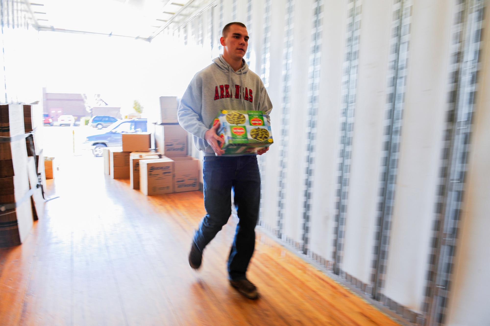 DENVER -- Senior Airman Torrey Erbes, 460th Security Forces Squadron armorer, loads donated canned goods in a moving truck during a Fill the Mayflower food drive Oct. 26, 2012, at a local grocery store. Fill the Mayflower is part of the efforts of Operation Warm Heart, a charter facilitated by the Team Buckley First Sergeants Council, to help junior enlisted service members in need. (U.S. Air Force photo by Staff Sgt. Kathrine McDowell)