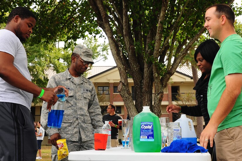 (Right) Staff Sgt. Christopher Cobb, 628th Medical Operations Squadron Air Force Alcohol and Drug Abuse Prevention and Treatment noncommissioned officer in charge, educates Airmen on the drinking laws during the 2012 Oktoberfest Oct. 26, 2012 at Joint Base Charleston - Air Base, S.C. Oktoberfest is an annual event put together by the First Six for ranks E-1 through E-6 to show appreciation for their day-to-day hard work. The event included free food and drinks, a disc jockey and a hot wing eating contest. Airmen also played games such as basketball and corn hole.