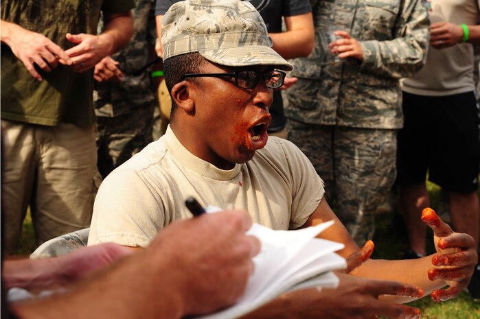 Airman 1st Class Antwon Bauthu, 628th Logistics Readiness Squadron logistics planner, participates in a hot wing contest at the 2012 Oktoberfest Oct. 26 at Joint Base Charleston - Air Base, S.C.. Oktoberfest is an annual event put together by the First Six for ranks E-1 through E-6 to show appreciation for their day-to-day hard work. The event included free food and drinks, a disc jockey and a hot wing eating contest. Airmen also played games such as basketball and corn hole. (U.S. Air Force photo/ Airman 1st Class Chacarra Walker)