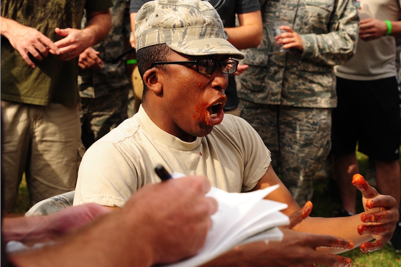 Airman 1st Class Antwon Bauthu, 628th Logistics Readiness Squadron logistics planner, participates in a hot wing contest at the 2012 Oktoberfest Oct. 26 at Joint Base Charleston - Air Base, S.C.. Oktoberfest is an annual event put together by the First Six for ranks E-1 through E-6 to show appreciation for their day-to-day hard work. The event included free food and drinks, a disc jockey and a hot wing eating contest. Airmen also played games such as basketball and corn hole. (U.S. Air Force photo/ Airman 1st Class Chacarra Walker)